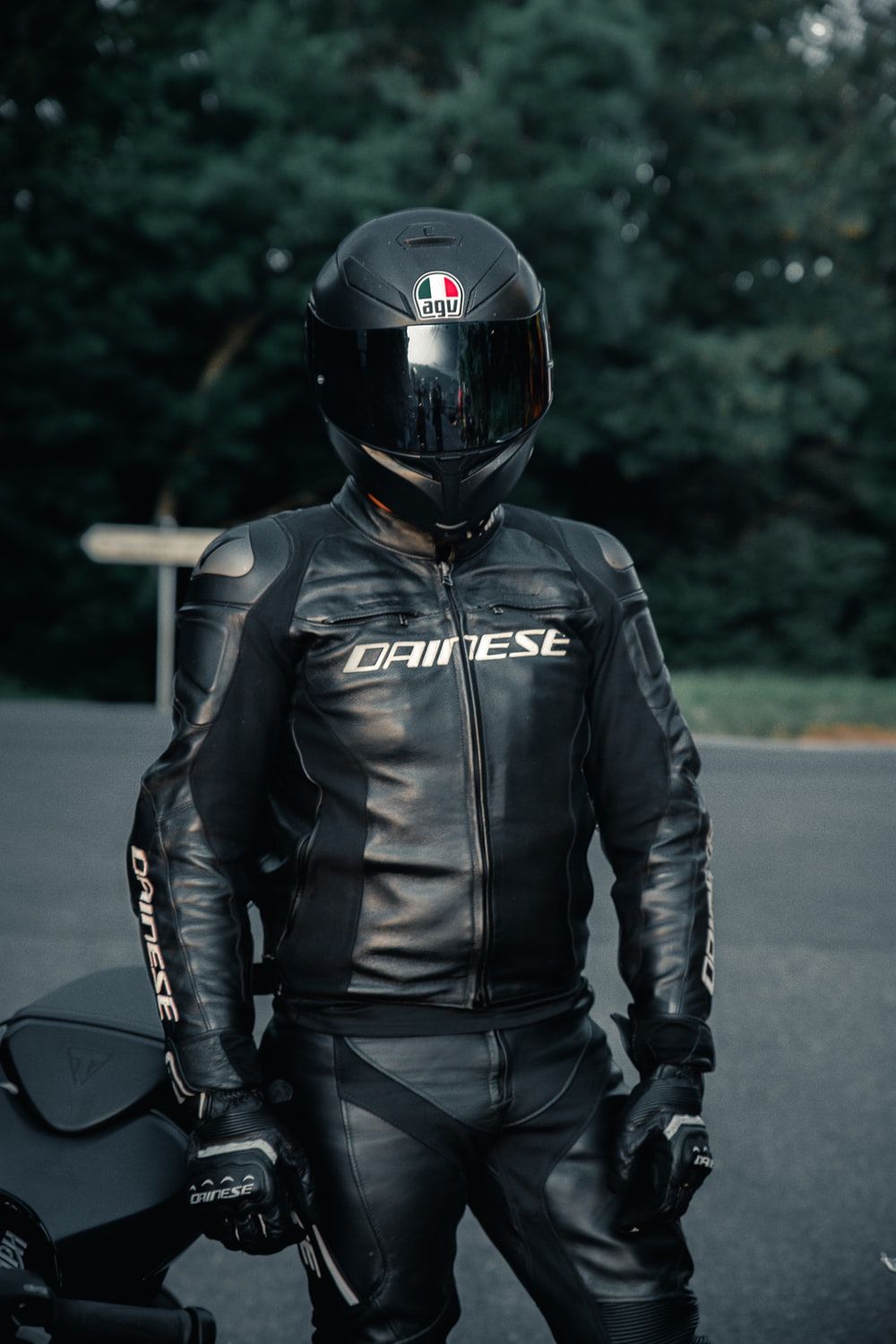 man in black leather jacket wearing black helmet photo