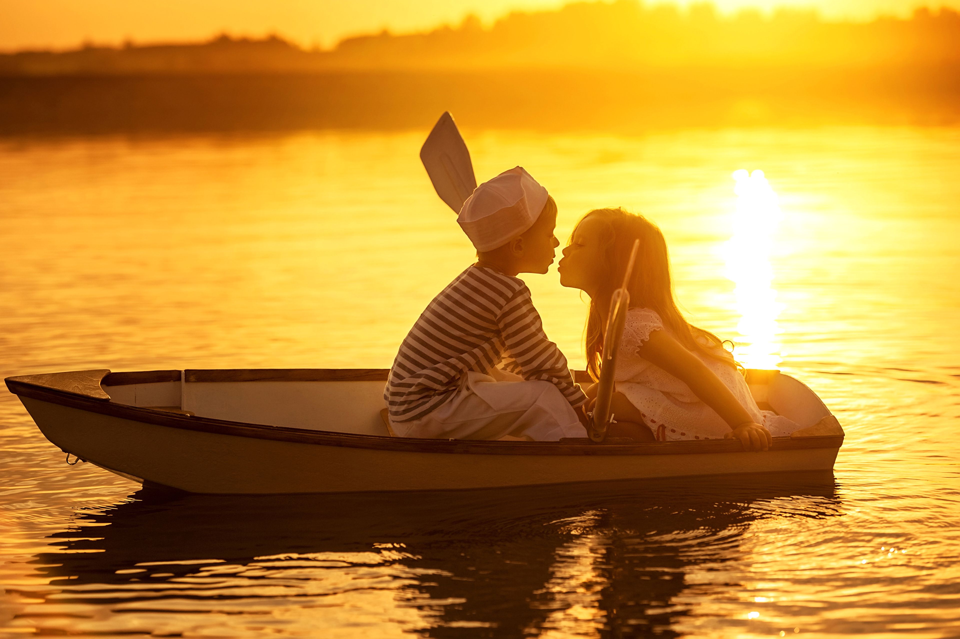 Kids Kissing Boat River Sunset 4K Wallpaper