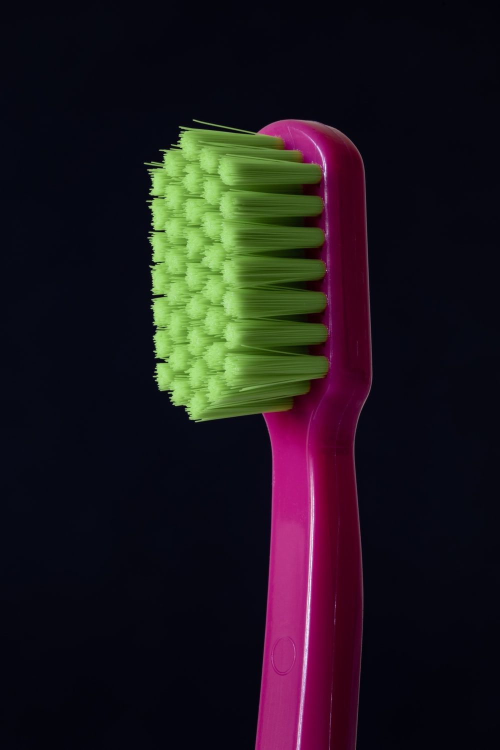 closeup photo of purple and green toothbrush photo