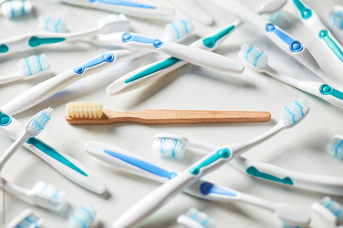 Bamboo Toothbrush Amongst Plastic Ones. by Martí Sans, Organic