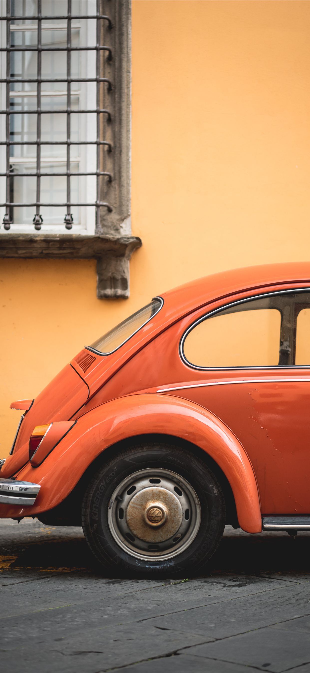 shallow focus photo of orange Volkswagen Beetle iPhone X Wallpaper Free Download