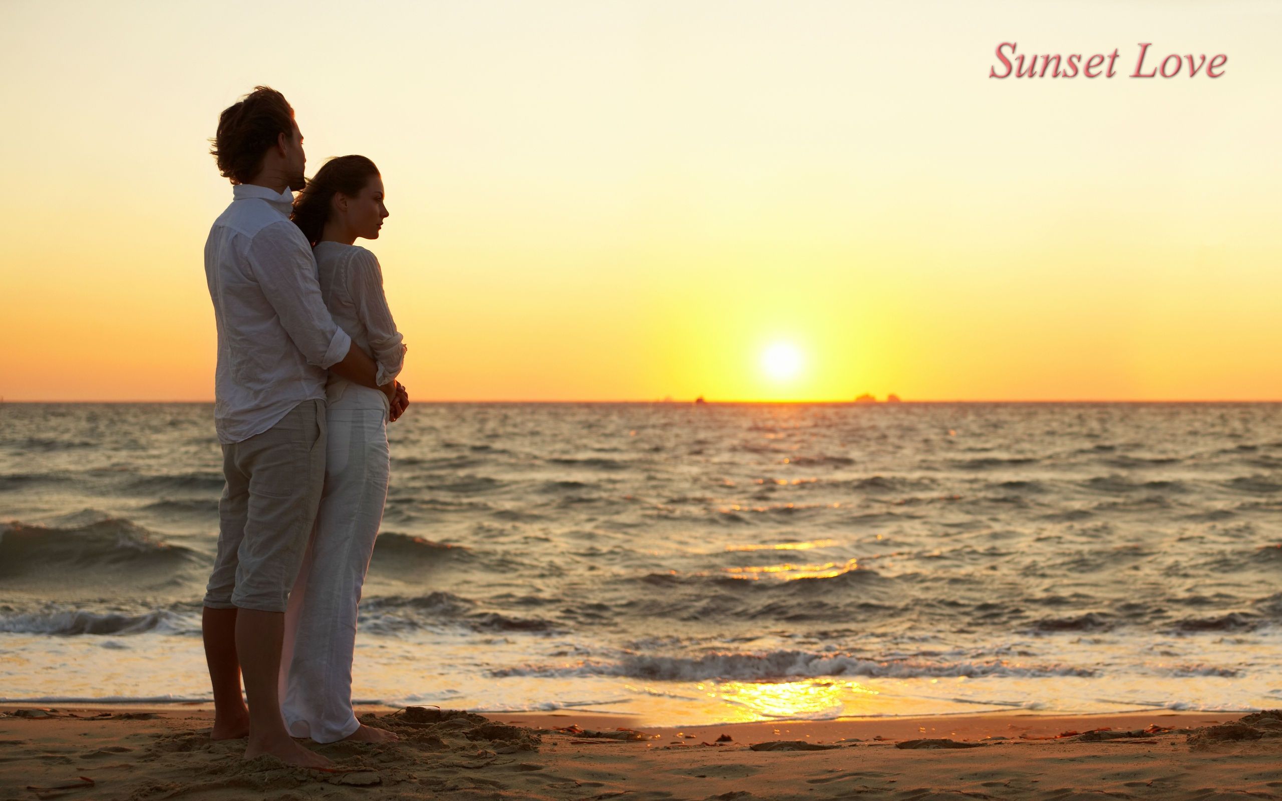 Couple On A Sunset Beach Wallpaper