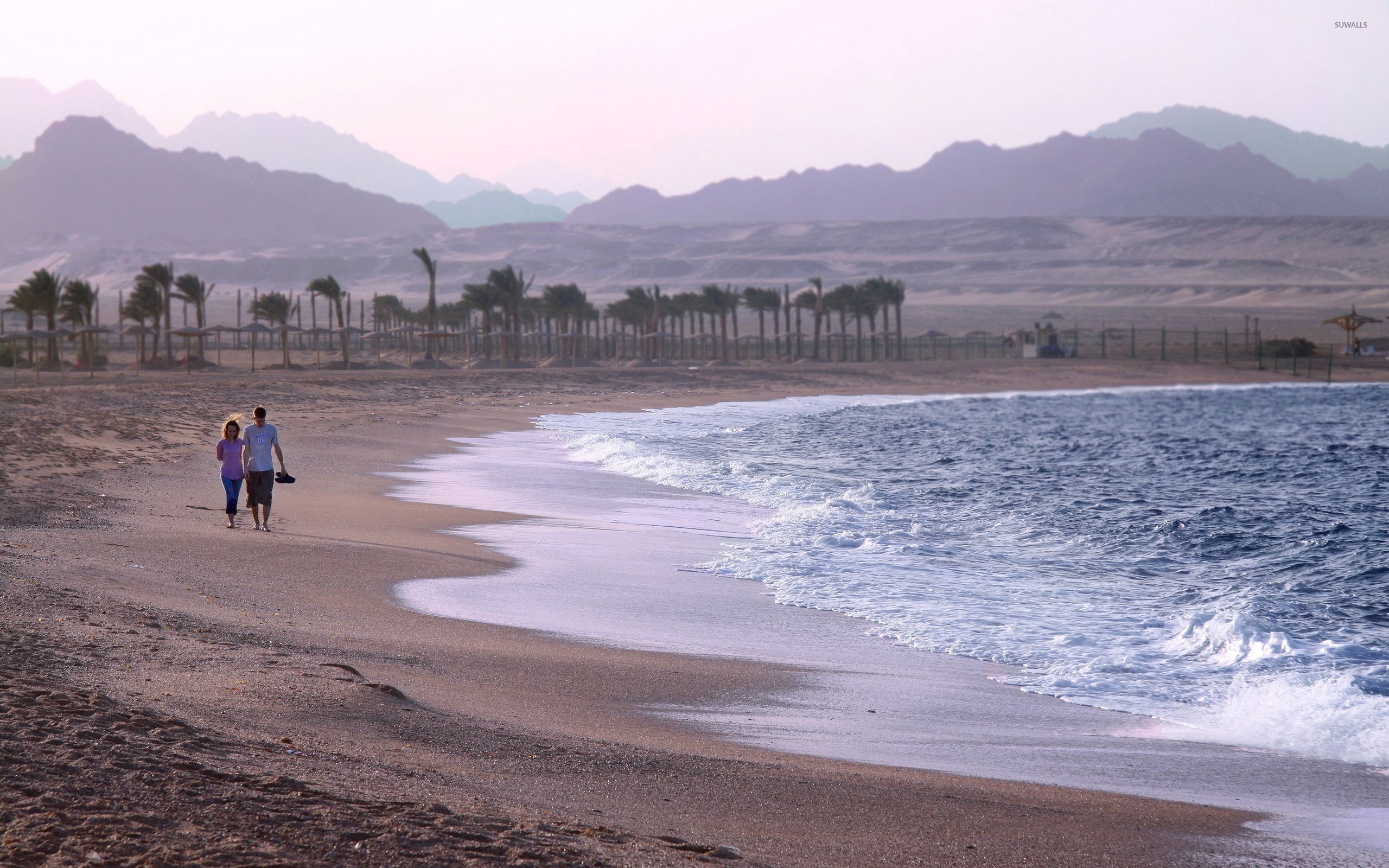 Couple taking a walk on the beach wallpaper wallpaper