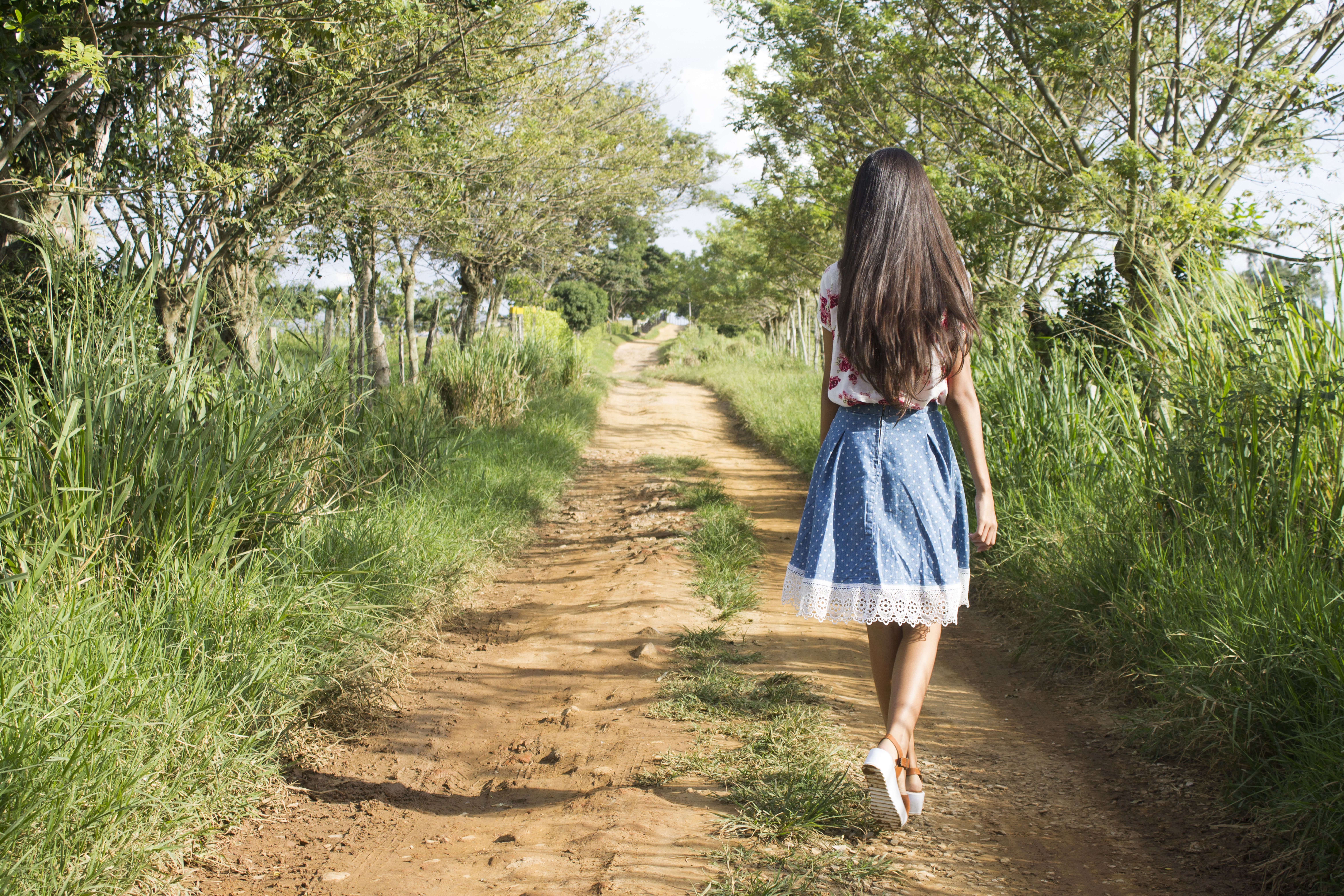Woman Wearing Blue and White Skirt Walking Near Green Grass during Daytime · Free