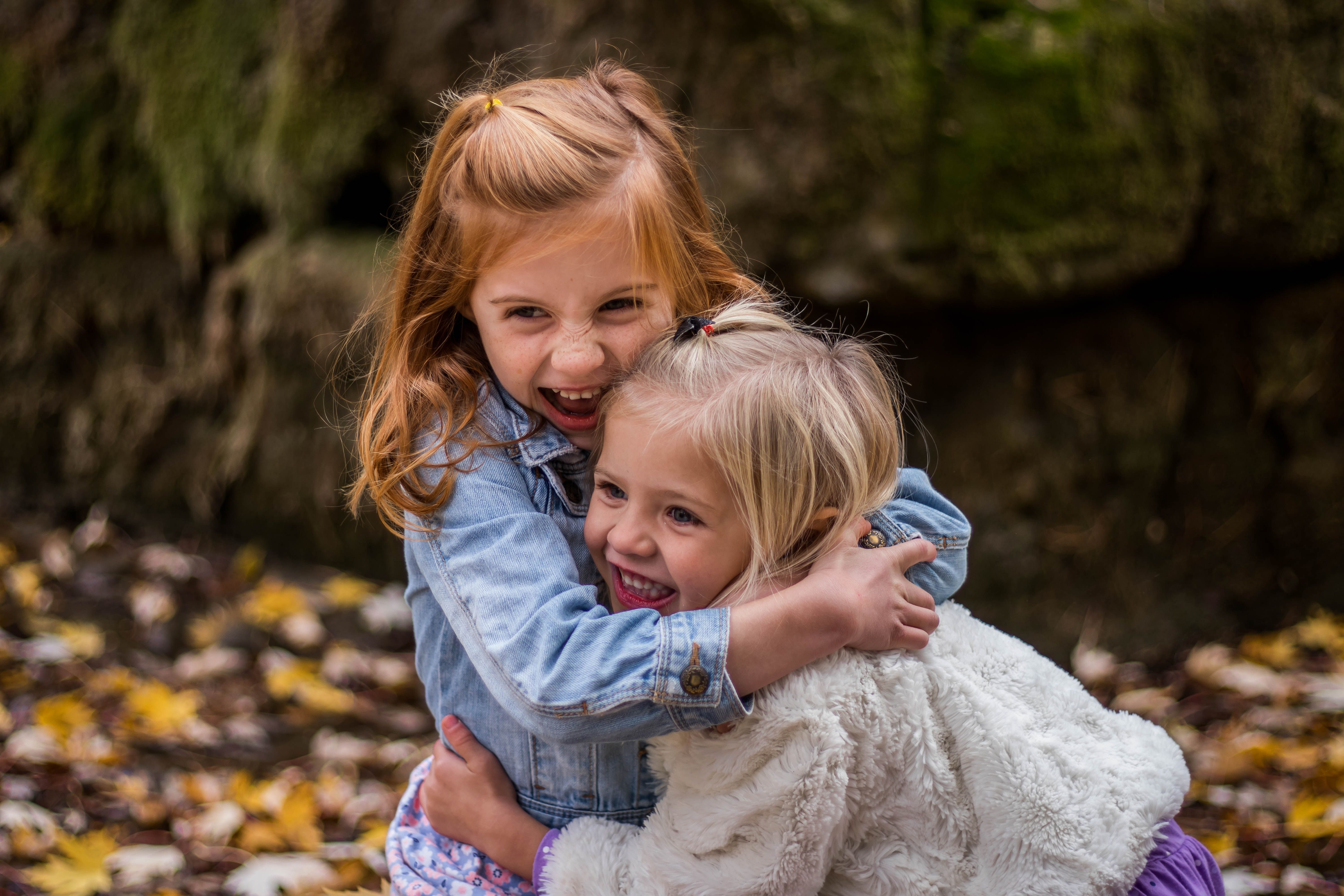 Girls Hugging Each Other Outdoor during Daytime · Free