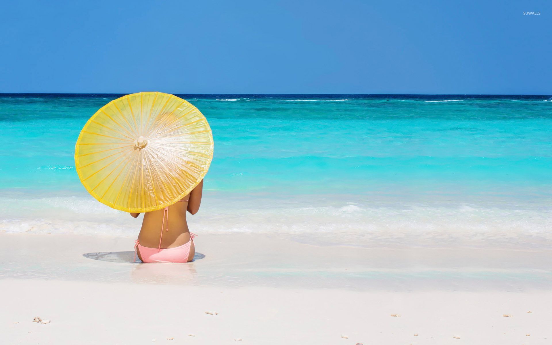 Girl with a yellow umbrella in the sand wallpaper wallpaper