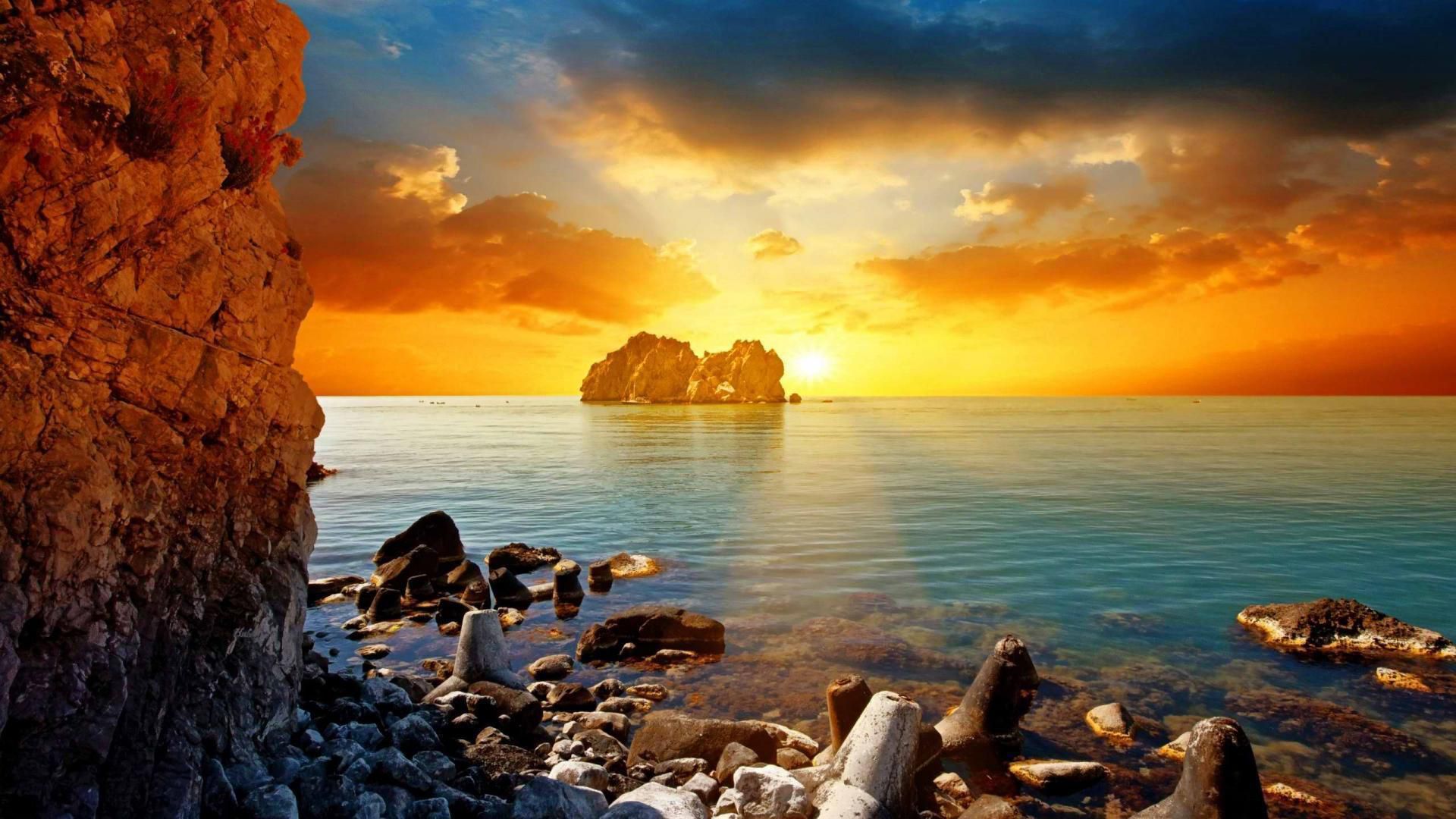 Sea And Rocks Under Cloudy Sky With Yellow Sunset HD Sunset Wallpaper