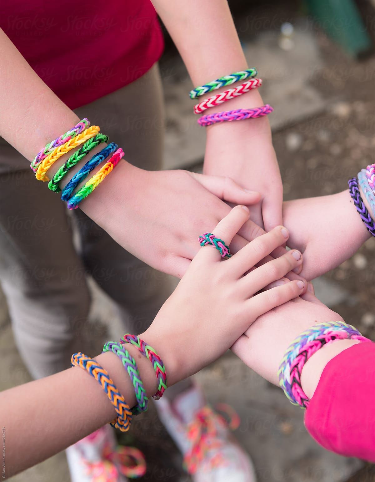 girls wrists adorned with colourful bracelets made from rubber bands. Best friend bracelets, Friend bracelets, Friends forever picture