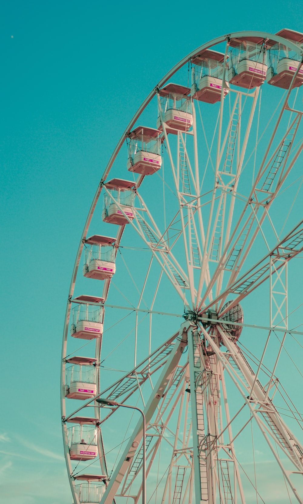 photo of red and white Ferris wheel during daytime photo