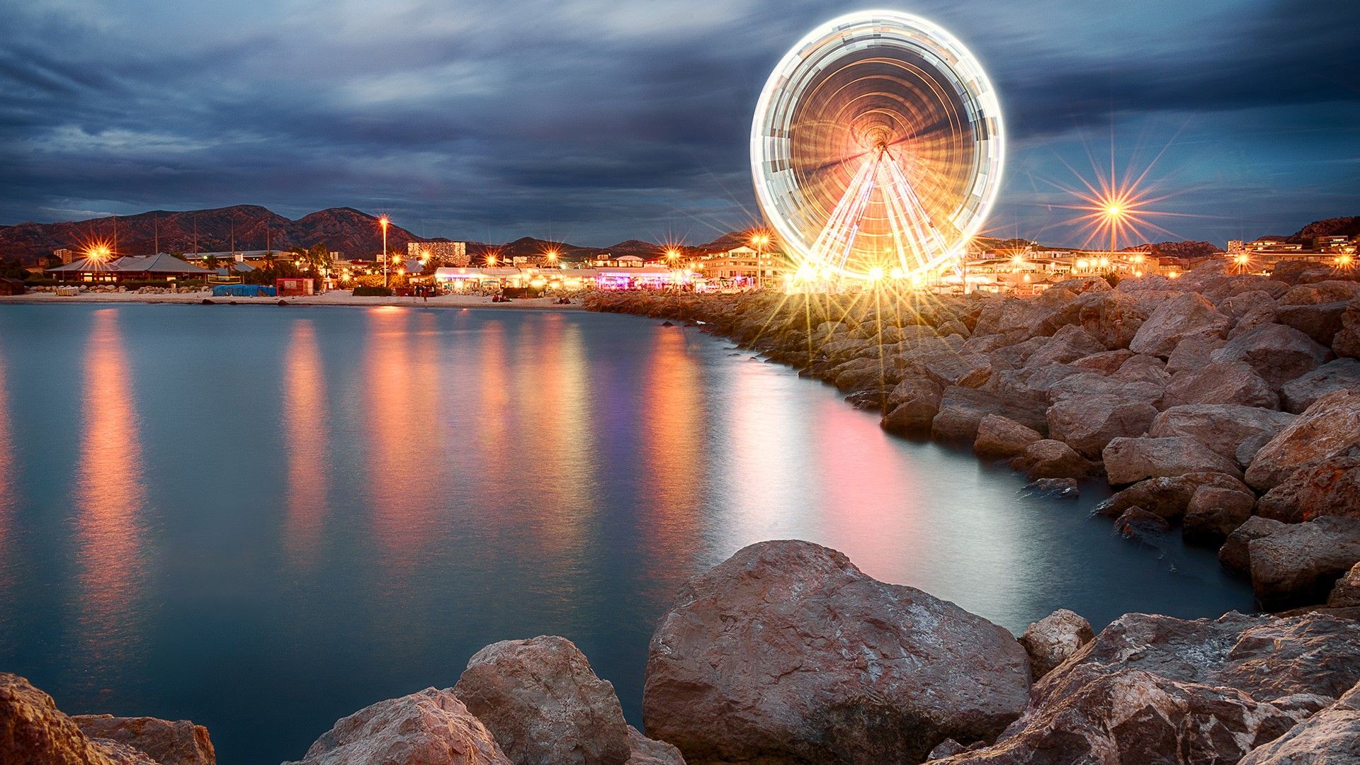 Ferris wheel in Old Port, summer evening in Marseille, France. Windows 10 Spotlight Image