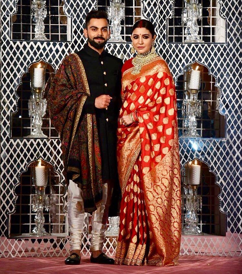 Anushka Sharma and Virat Kohli at their wedding reception in New Delhi. Jewelry by Sabyasachi. Reception sarees, Indian wedding outfits, Reception saree