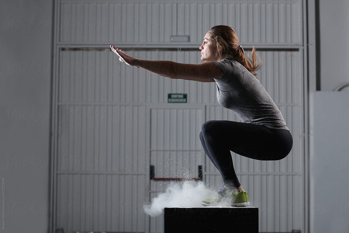Fit Woman Jumping On A Gym Box For Workout
