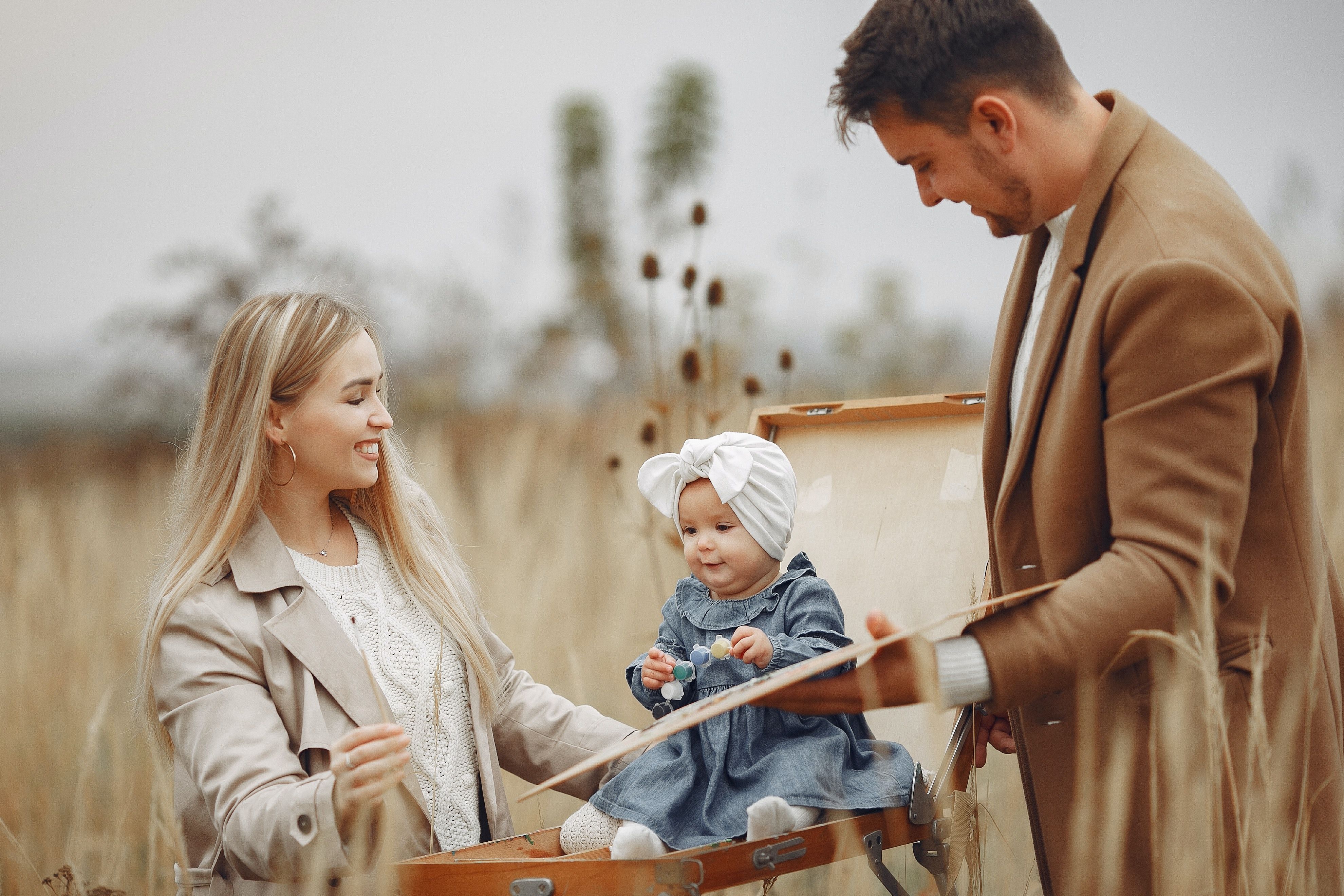 Young parents with cute baby in countryside in autumn · Free