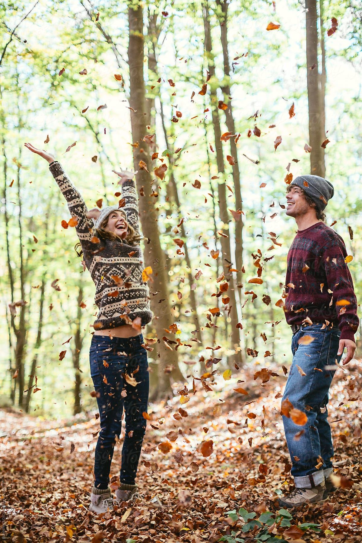 Couple In Love Playing With Leaves On The Woods In Autumn. by BONNINSTUDIO, Woods