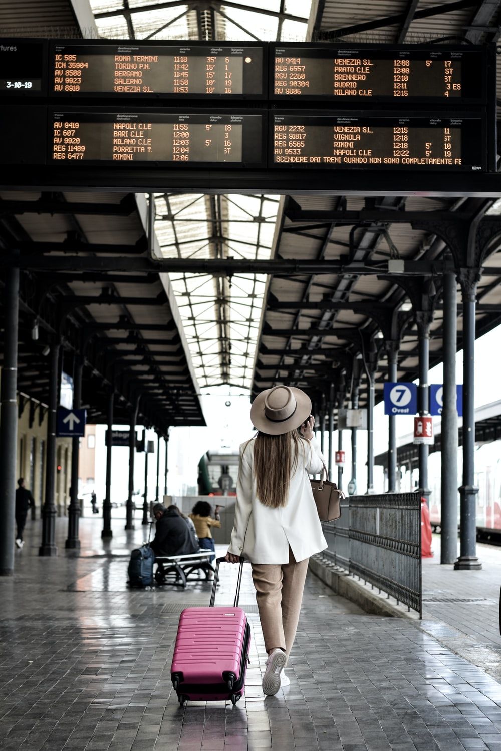 woman holding pink luggage photo