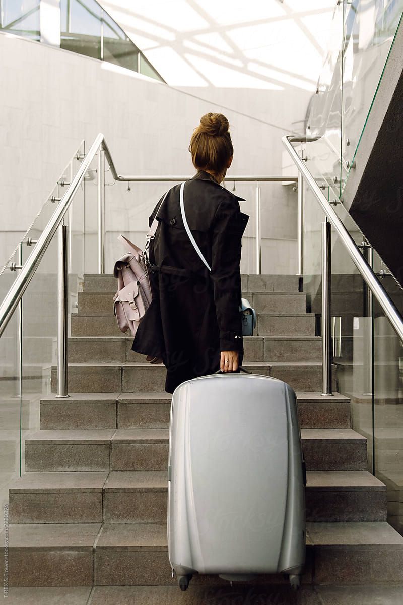 Young Woman With A Suitcase And Bag At The Airport. Stocksy United. Female travel, woman, Airport photo