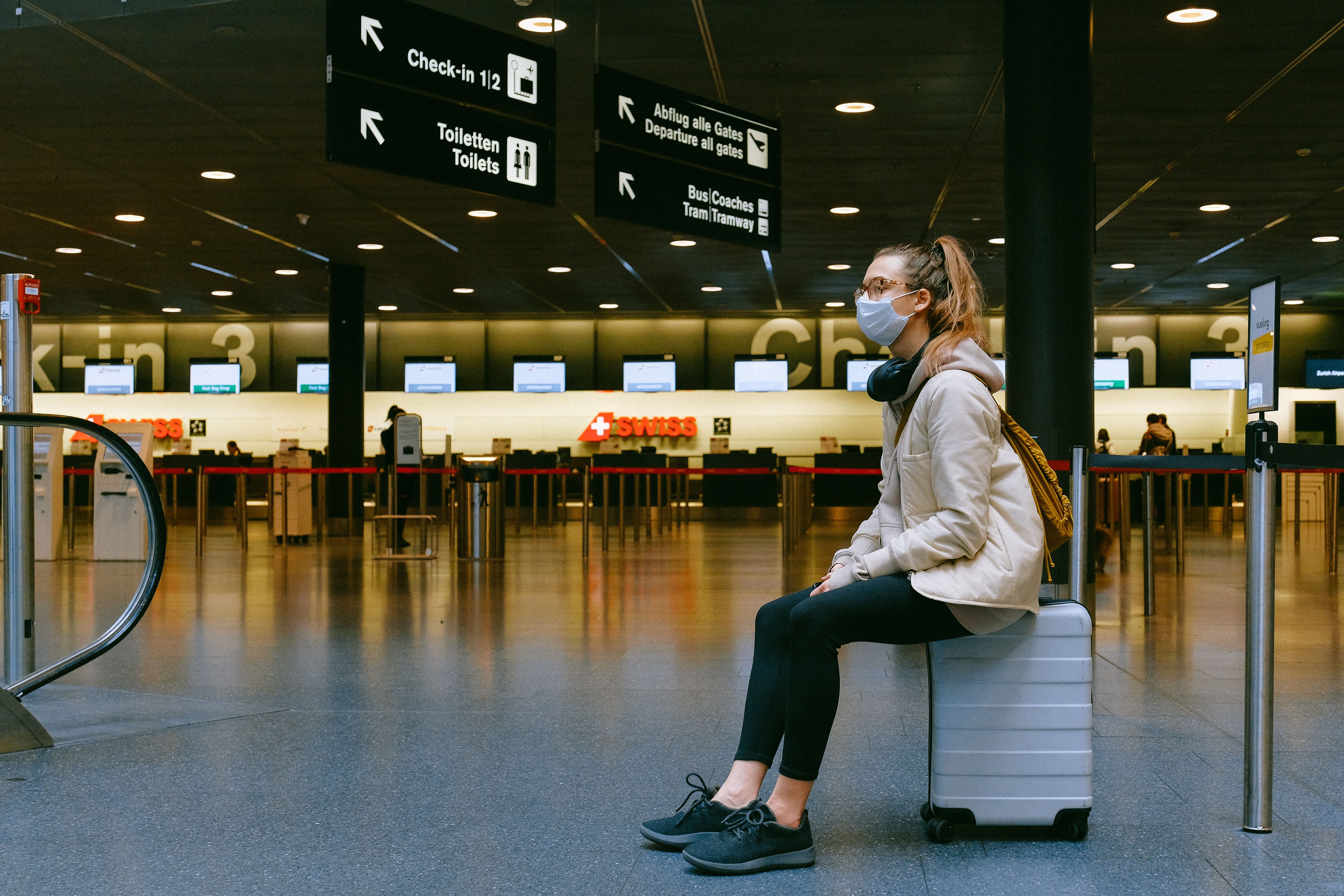 Woman Sitting on Luggage · Free