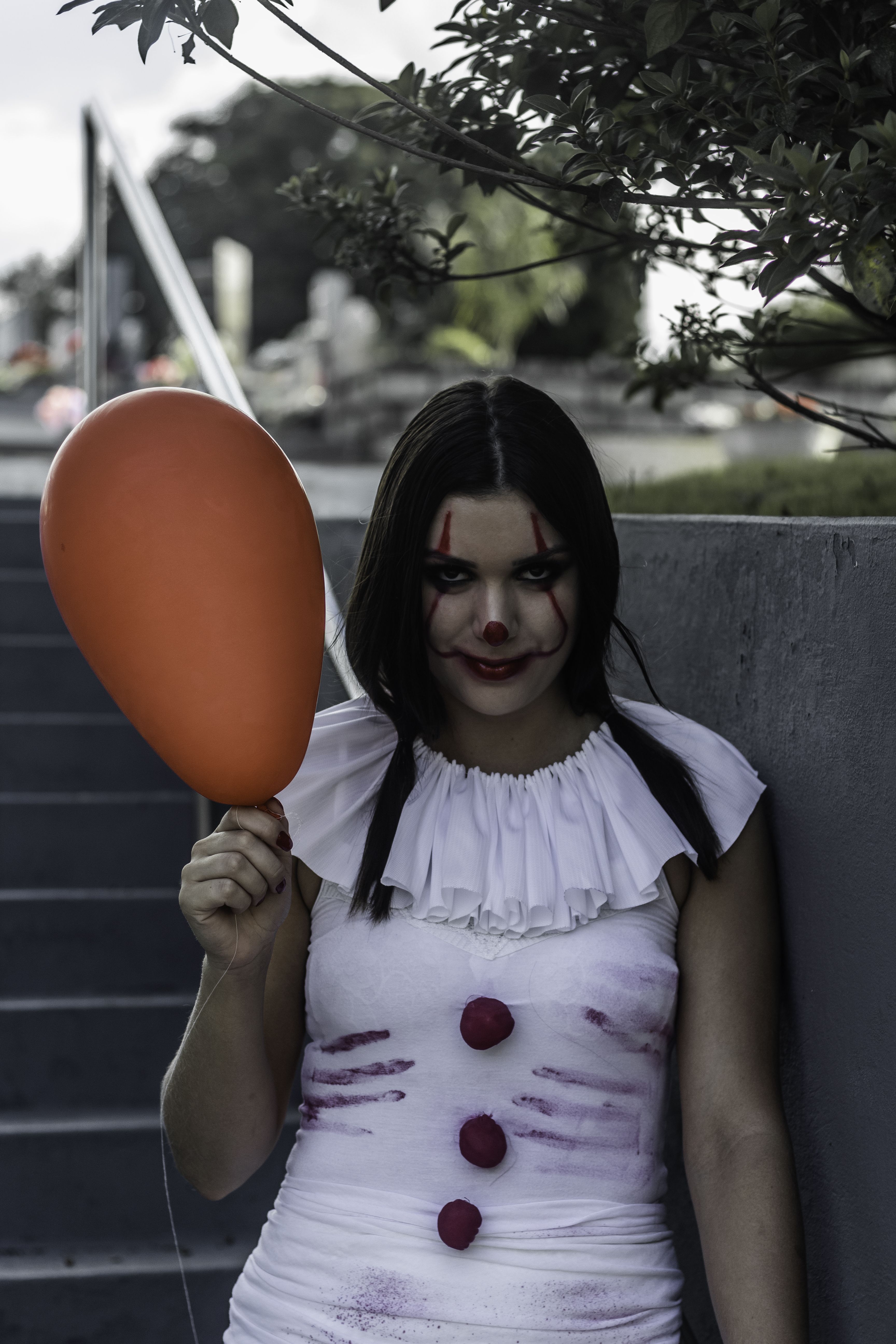 Creepy girl with clown makeup and balloon · Free