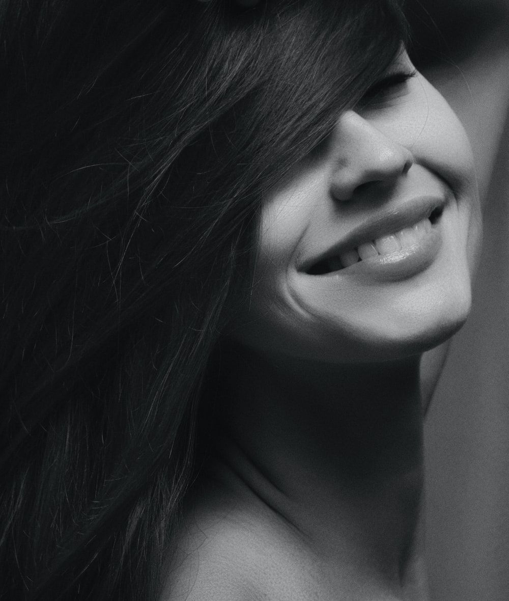 grayscale photography of smiling woman photo