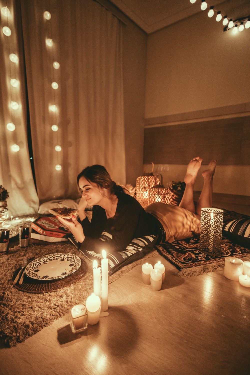 woman prawn lying on floor with lighted candles photo
