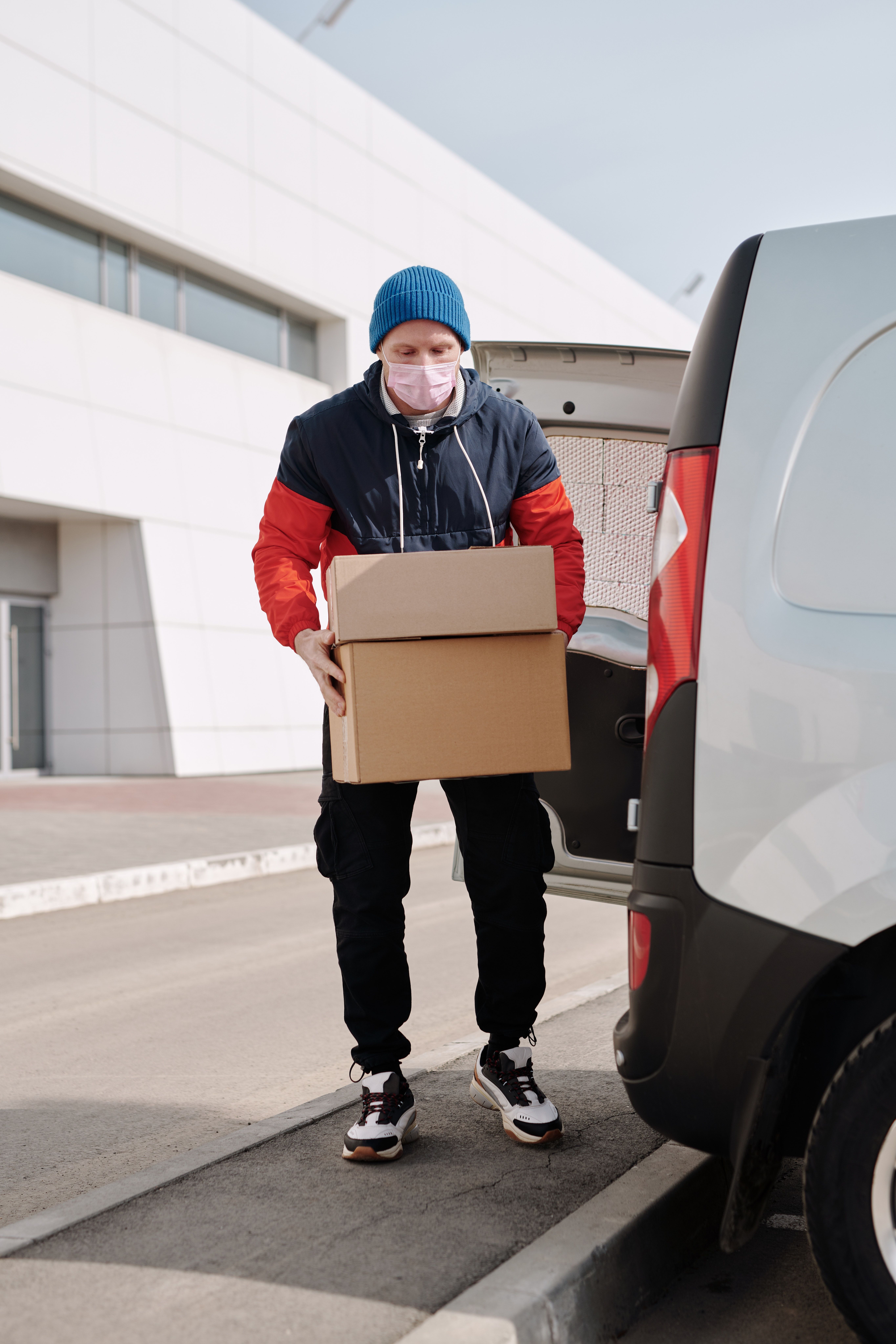Delivery Man Wearing a Face Mask Carrying Boxes · Free