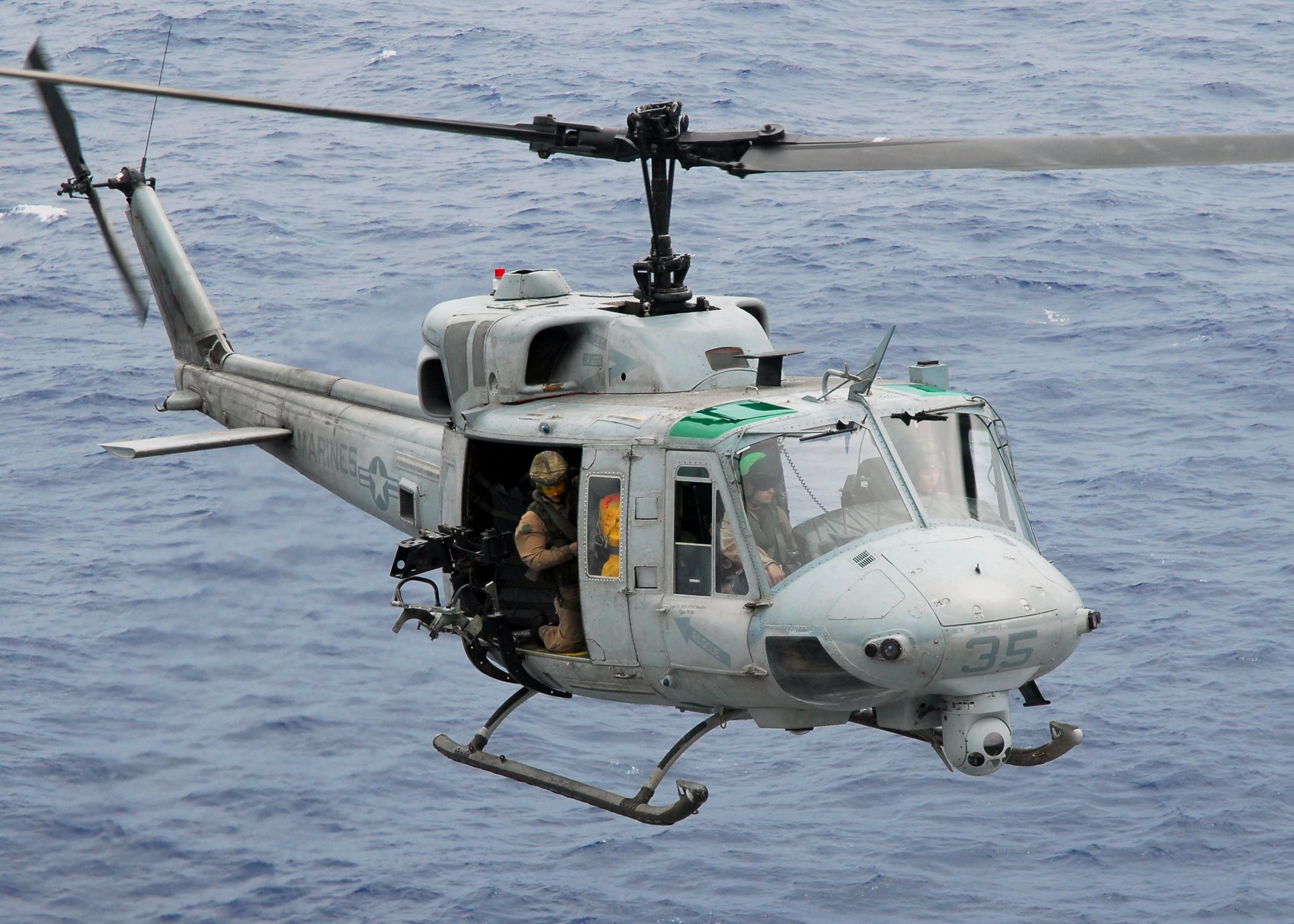 US Navy 081017 N 2183K 014 A UH 1N Twin Huey Helicopter Gunship Approaches The Flight Deck Of The Amphibious Assault Ship USS Peleliu (LHA 5)