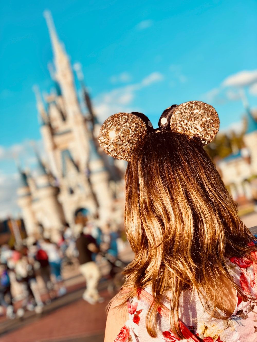 woman wearing golden Mickey Ears at Disneyland photo
