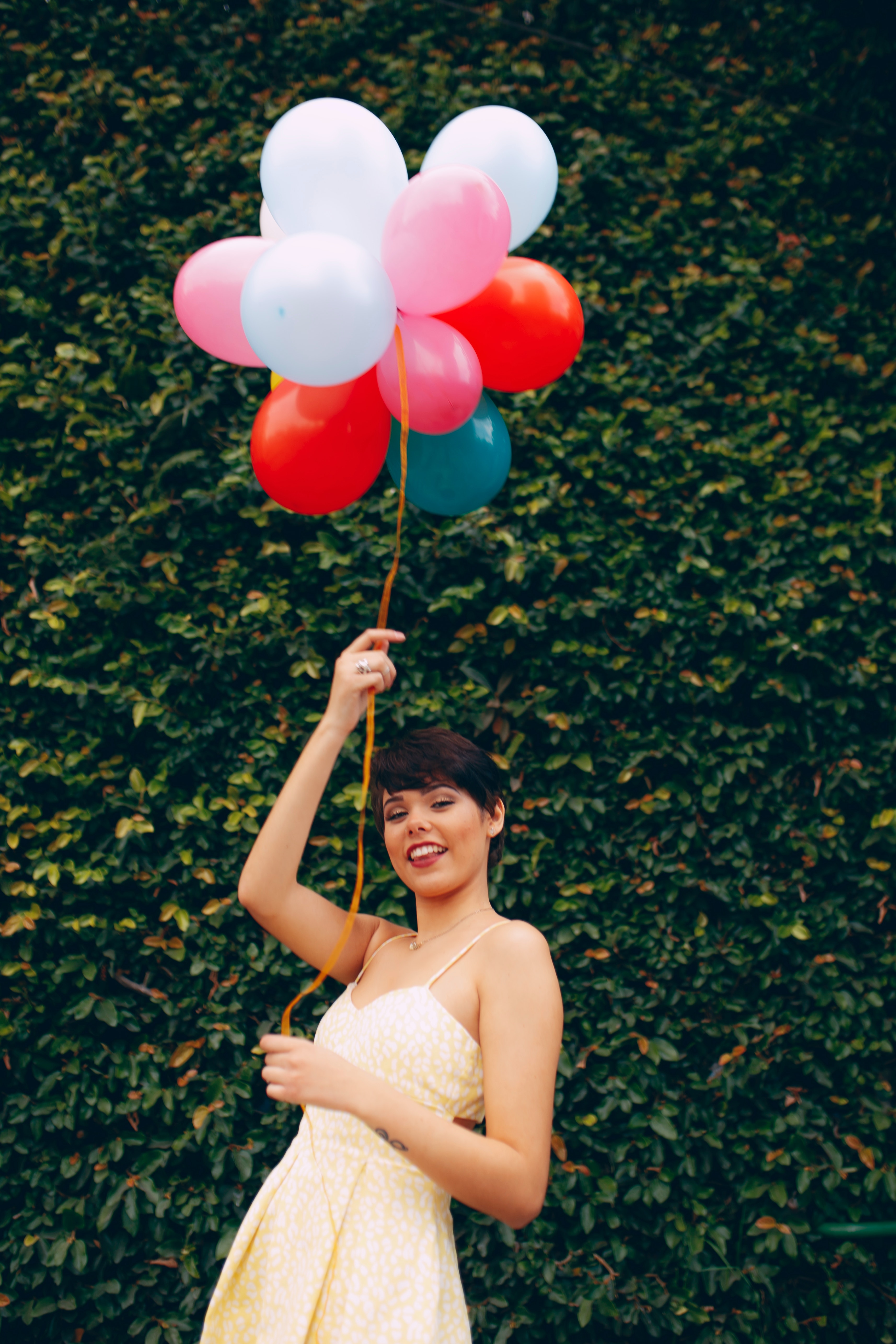 Photo of Smiling Woman Holding Balloons · Free