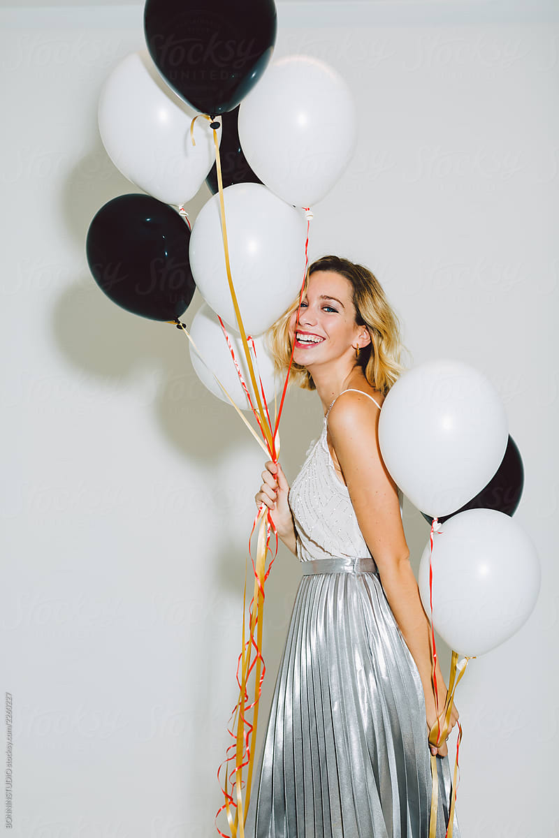 Smiling Beautiful Woman Holding Balloons In A New Year Party Celebration