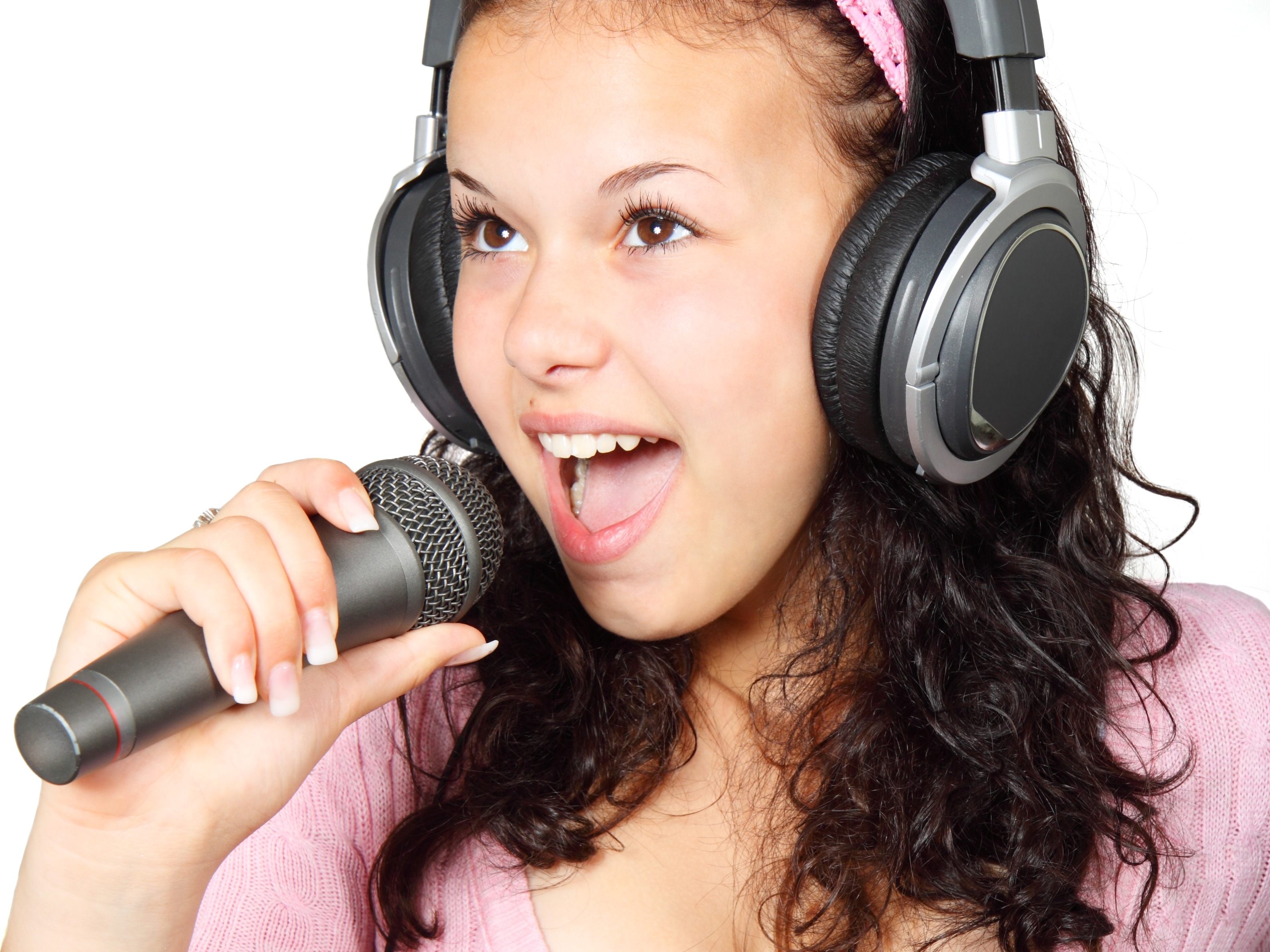 A Girl Holding a Microphone With a Headphone · Free