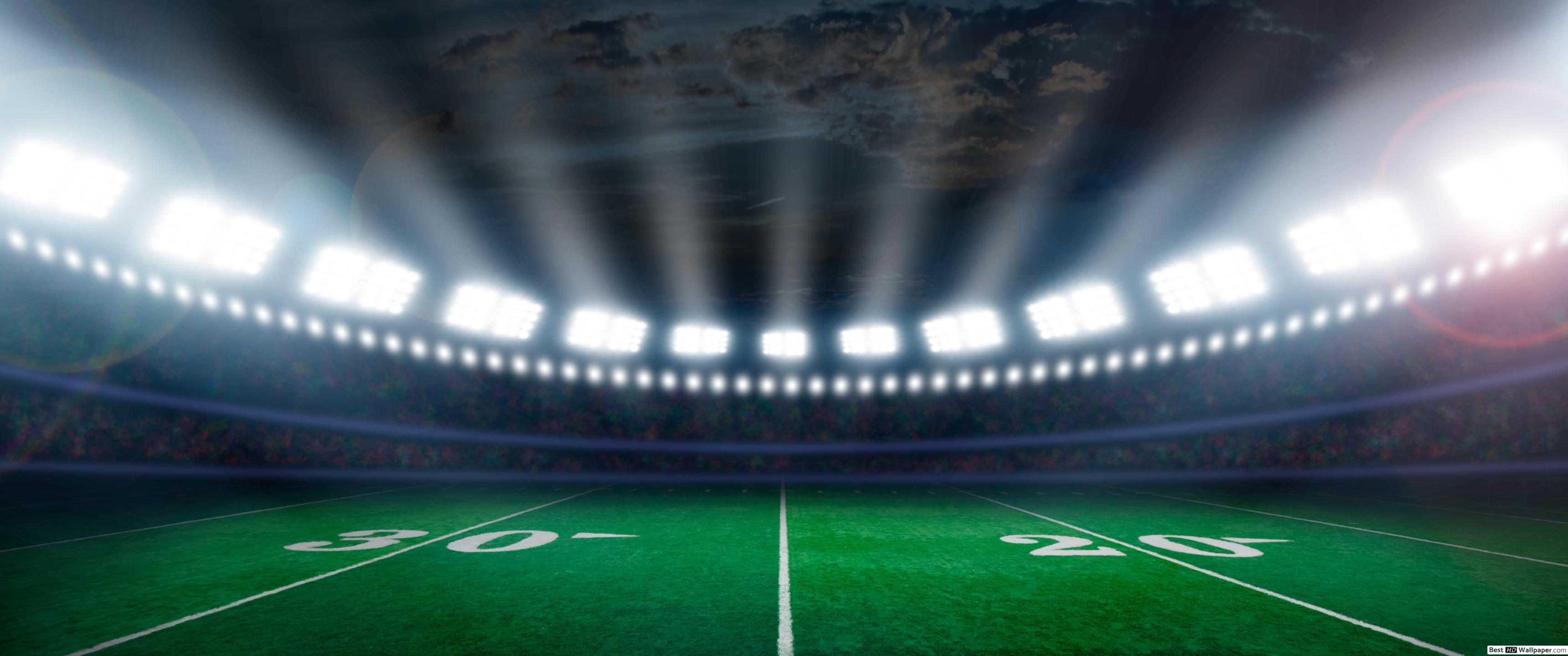 Football Field Illuminated By Stadium Lights