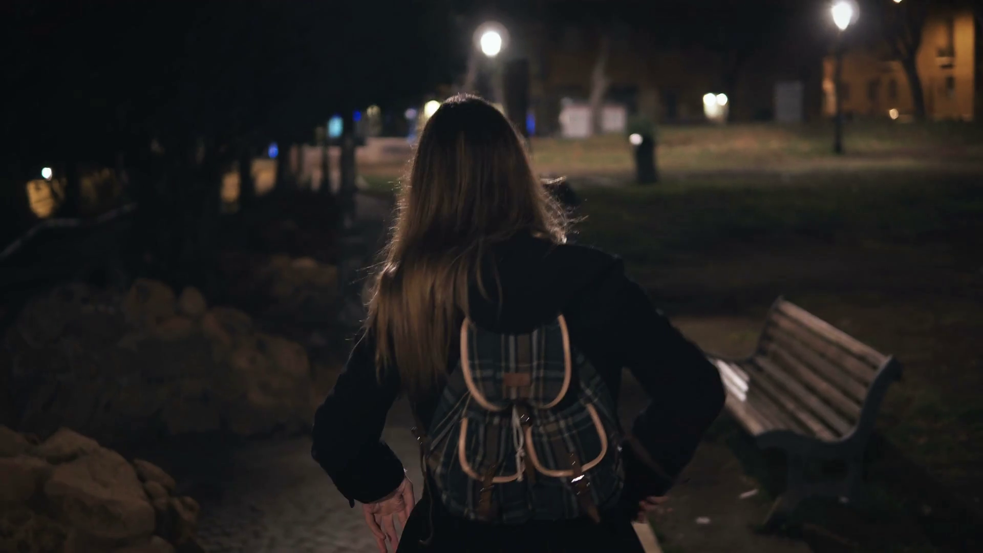 Back view of young stylish woman walking late at nightk park. going in the evening alone. Stock Video Footage