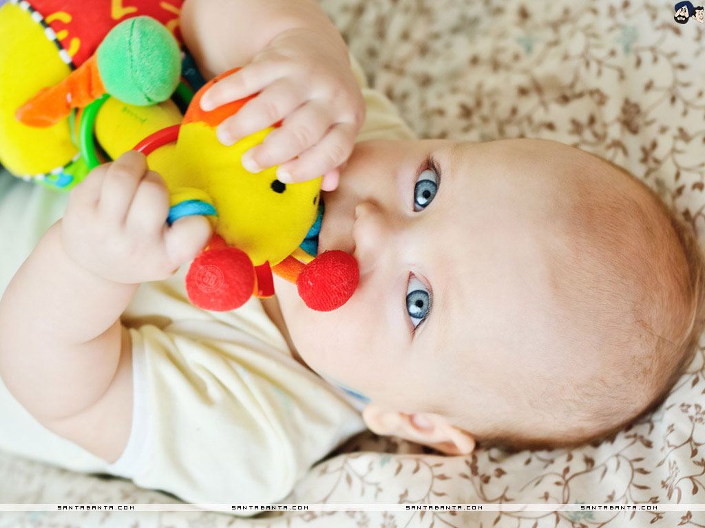 An adorable baby playing with a colorful toy