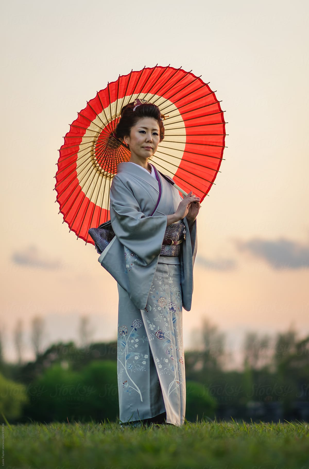 Japanese Woman Wearing Kimono And Holding Traditional Umbrella by Leslie Ta...