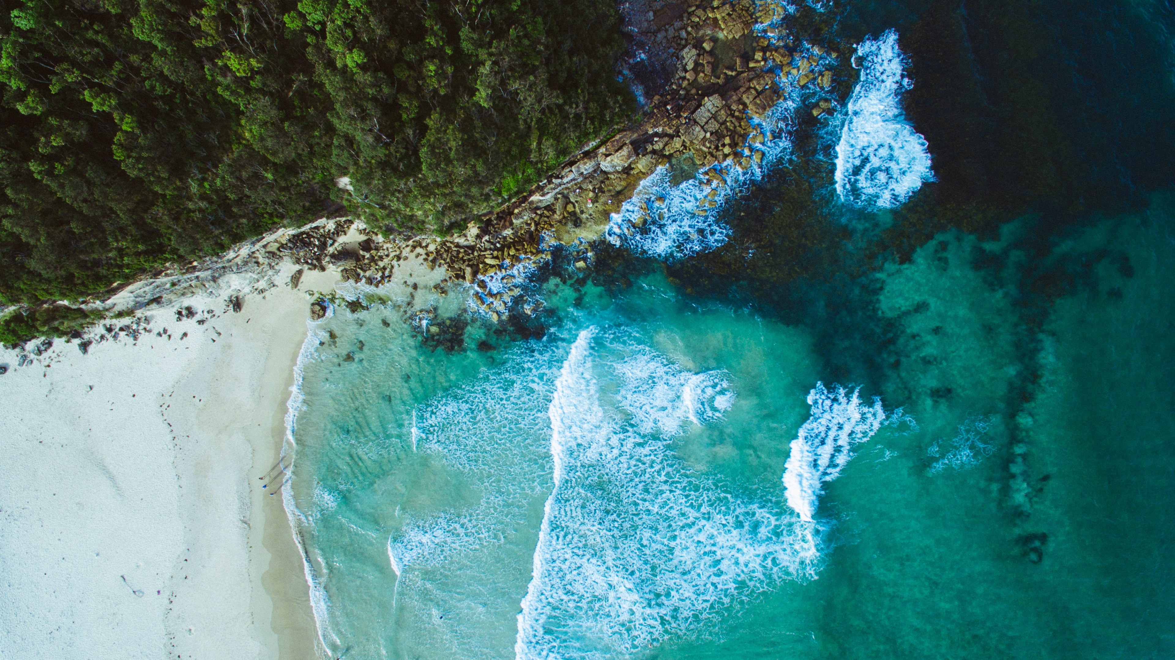 Wallpaper / drone aerial view of ocean waves washing on the sand beach by the cliffs, power 4k wallpaper