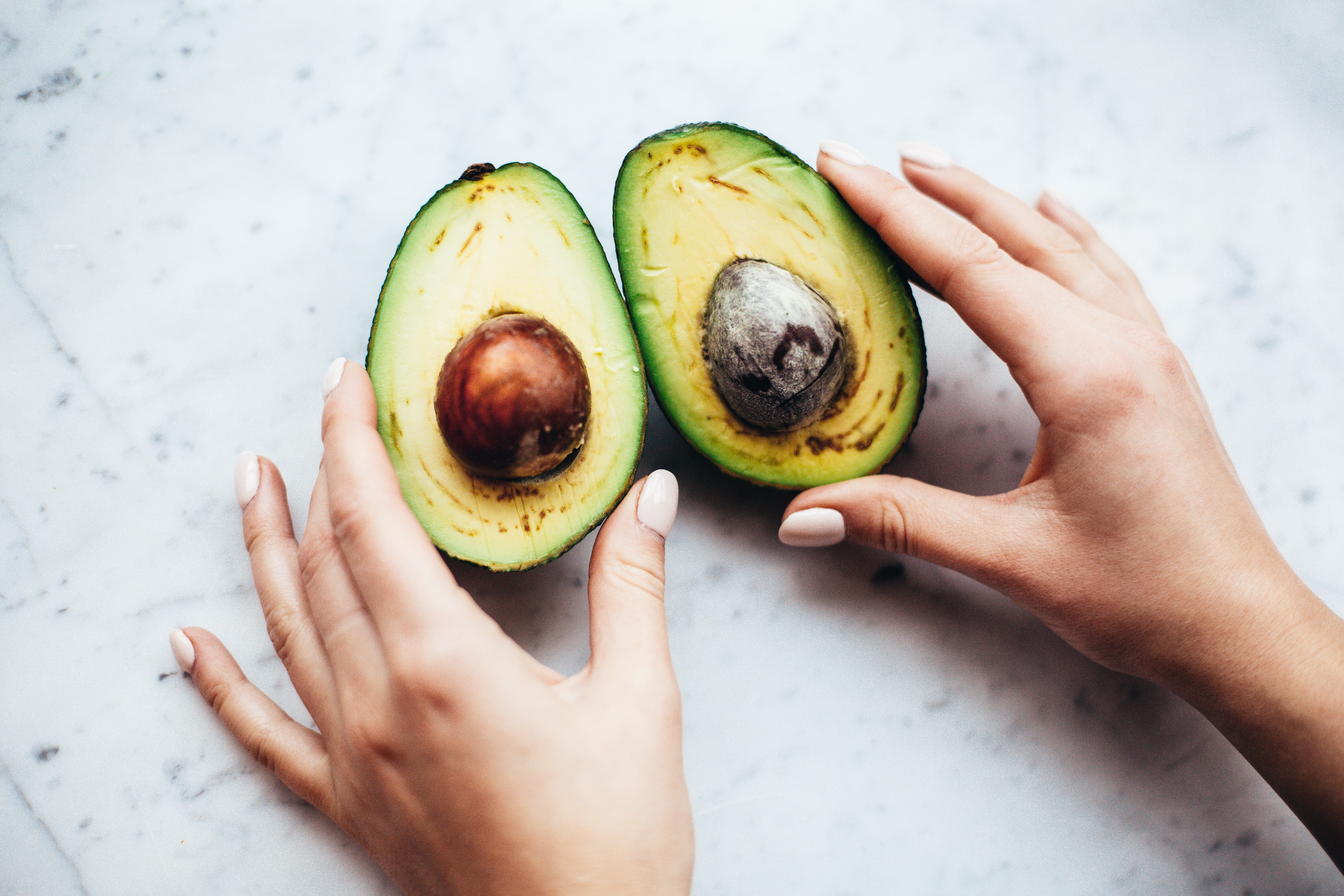 Person Holding Sliced Avocado · Free
