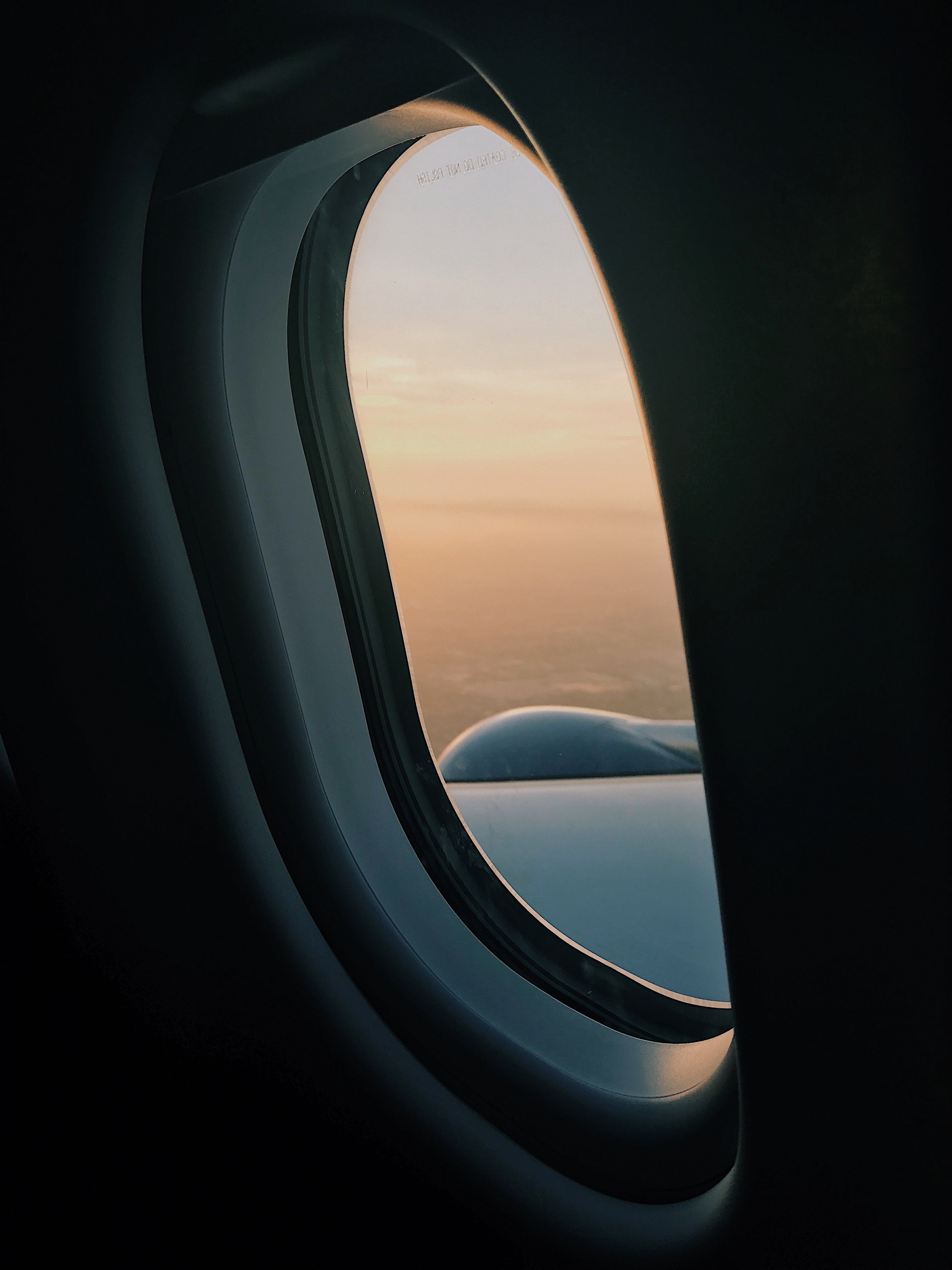 Wallpaper / looking out an airplane window at the planes wing and a blue skyline, plane and simple vol_2 4k wallpaper