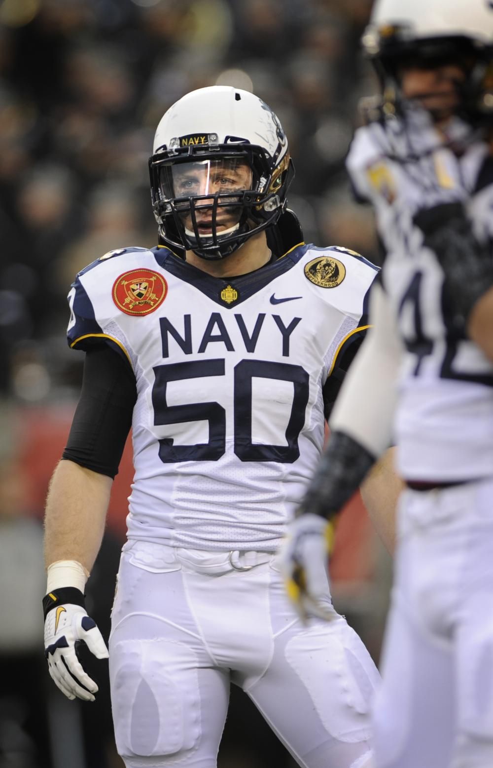 U.S. Navy Midshipman Brye French, a linebacker with the U.S. Naval Academy football team, watches the U.S. Milit. Navy football, Army navy football, Army football