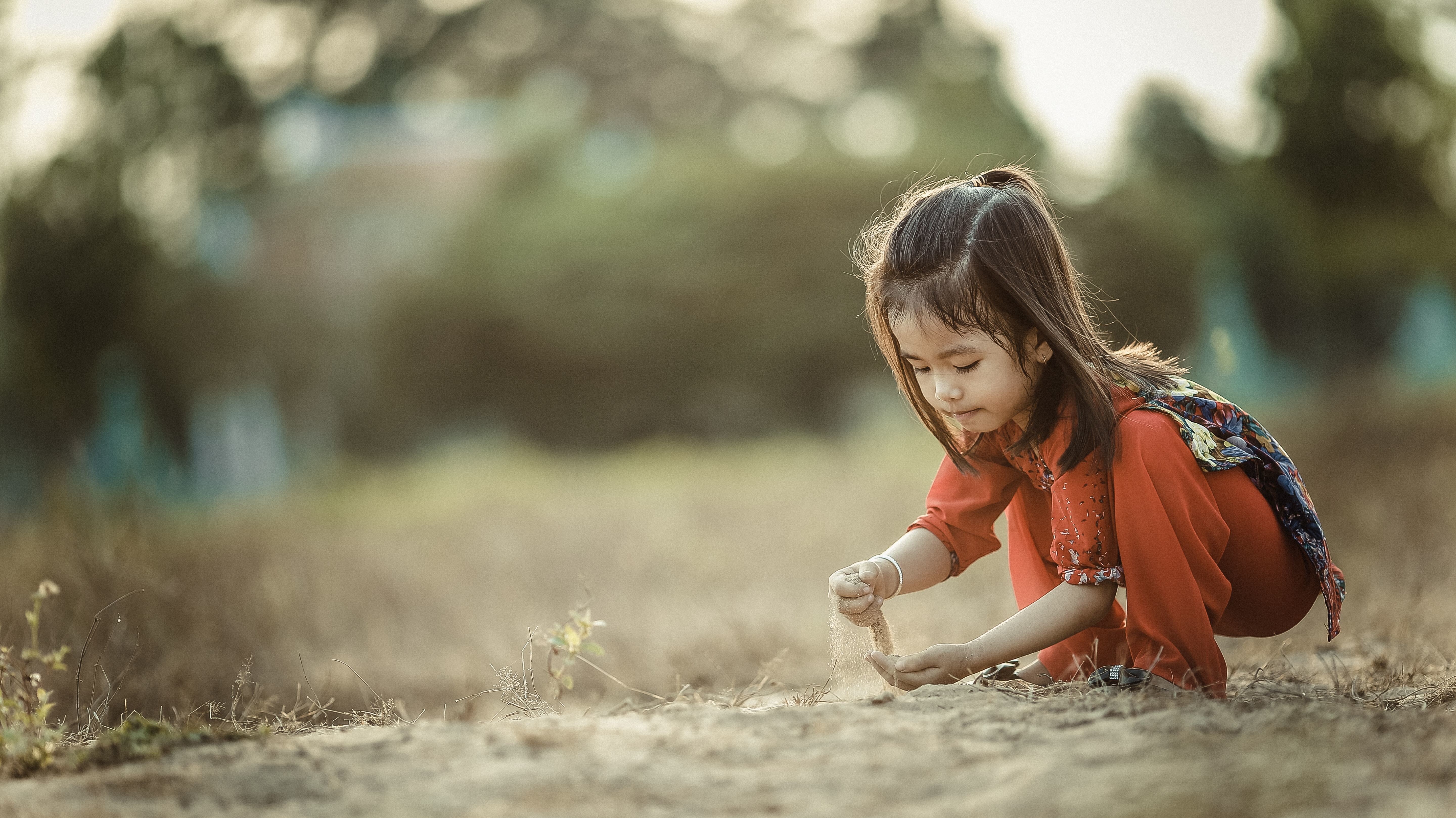 Cute Girl Child Playing with Sand Image