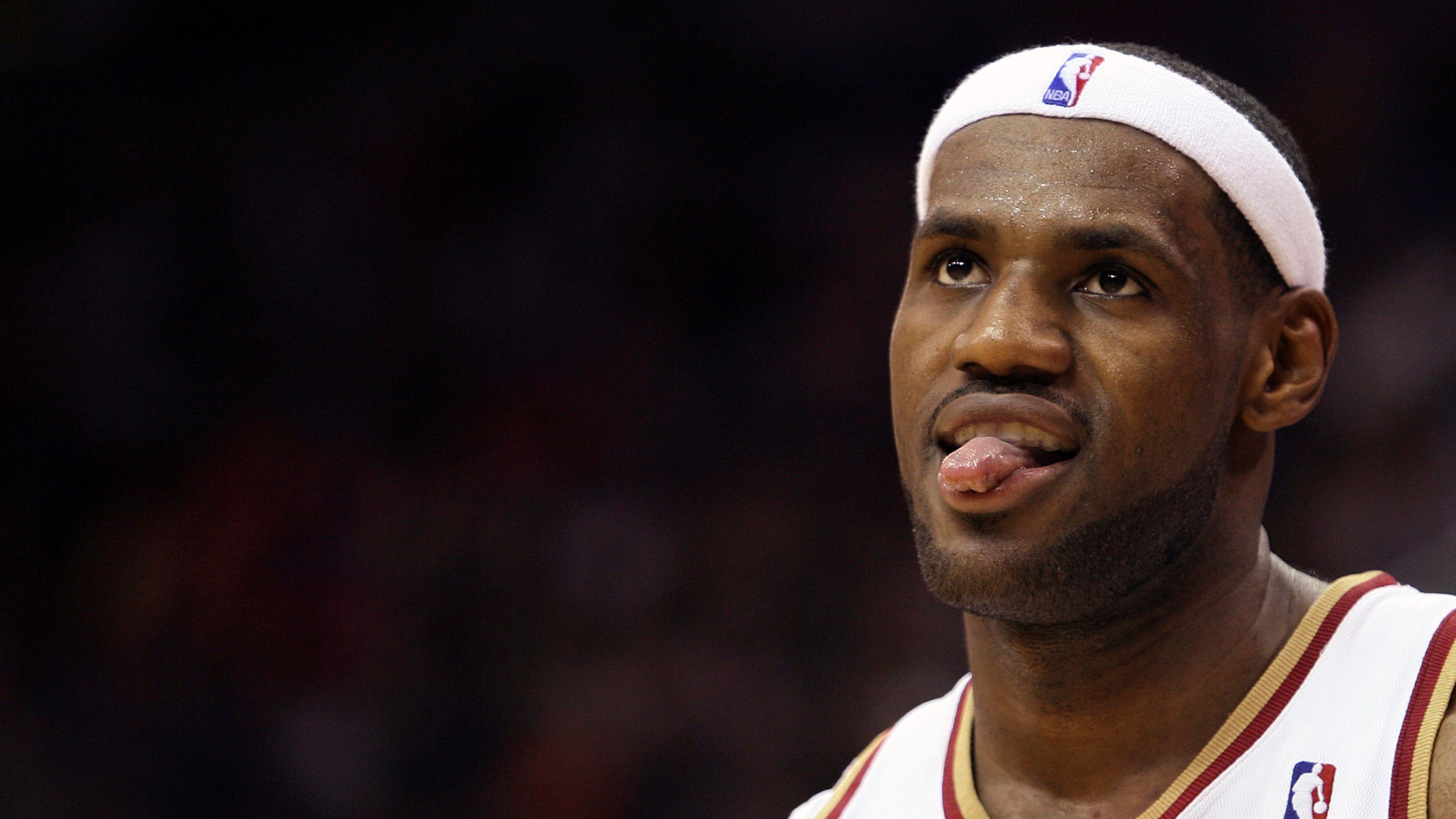 LeBron James Is Showing Tongue Out Standing In A Blur Black Background Wearing White Dress HD Sports Wallpaper
