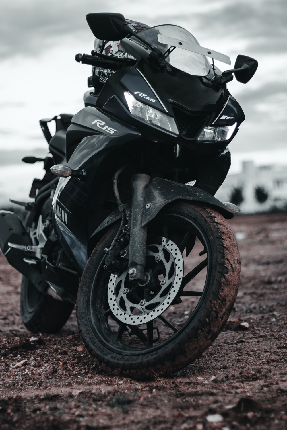 black sports bike on brown dirt road during daytime photo