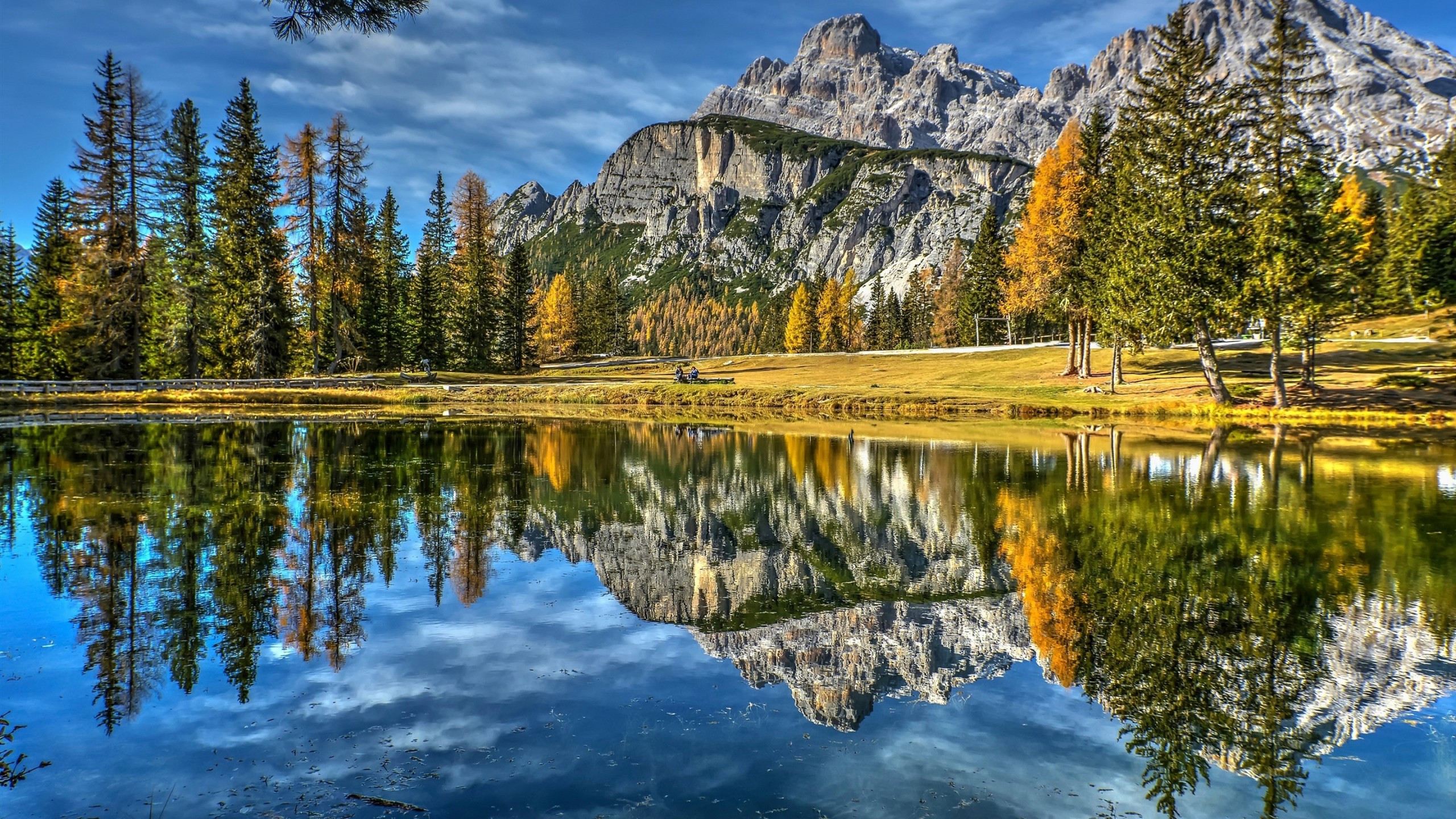 Download 2560x1440 Lake, Trees, Reflection, Italy, Dolomites, Mountains, Sky, Autumn Wallpaper for iMac 27 inch
