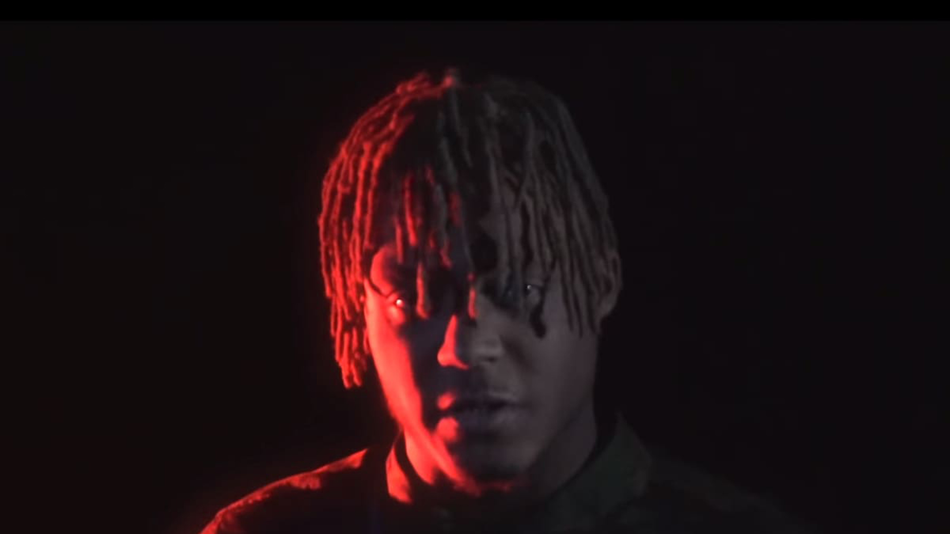 Juice Wrld In Black Background With Red Light On Face HD Juice Wrld Wallpaper