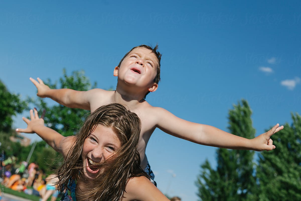 Girl Giving A Piggyback Ride To Her Little Friend