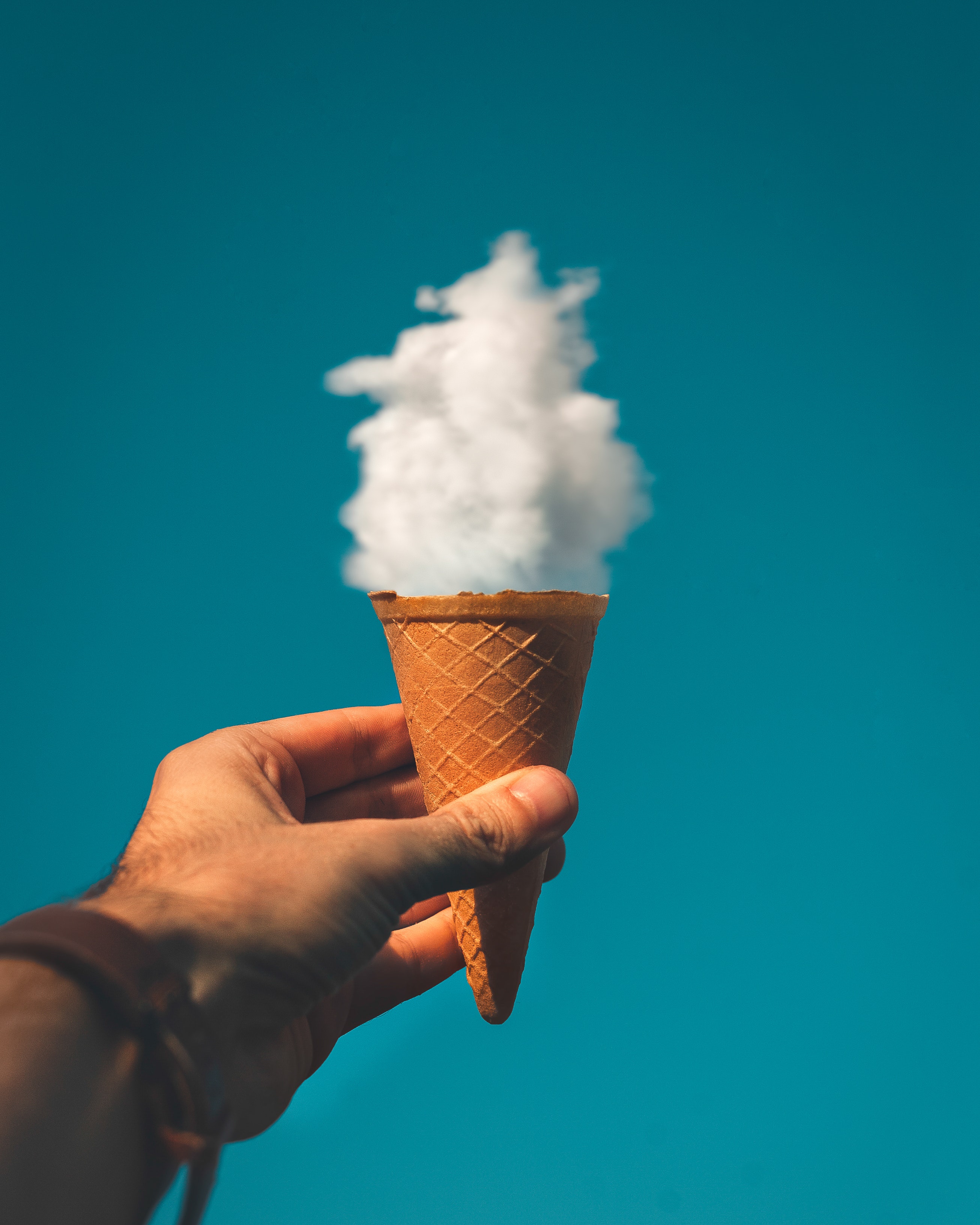 Man Holding Ice Cream Cone Under Cloud · Free