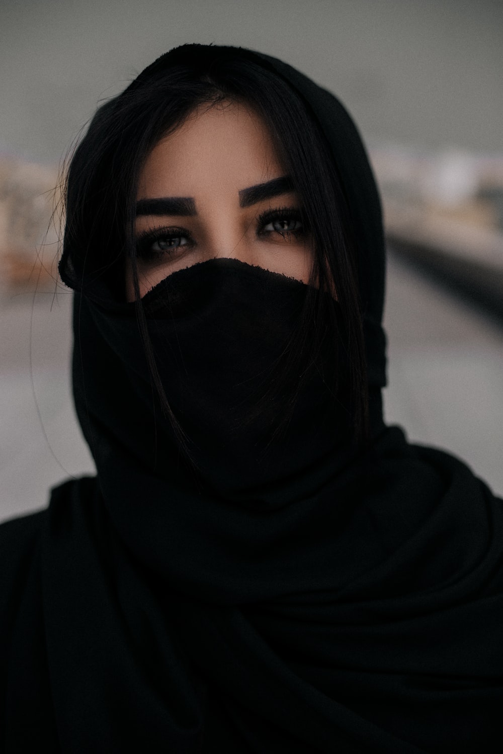 woman in black hijab taking selfie photo