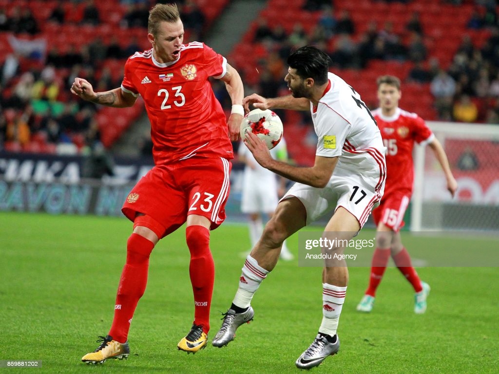 Dmitriy Tarasov of Russia in action against Mehdi Taremi of Iran. News Photo