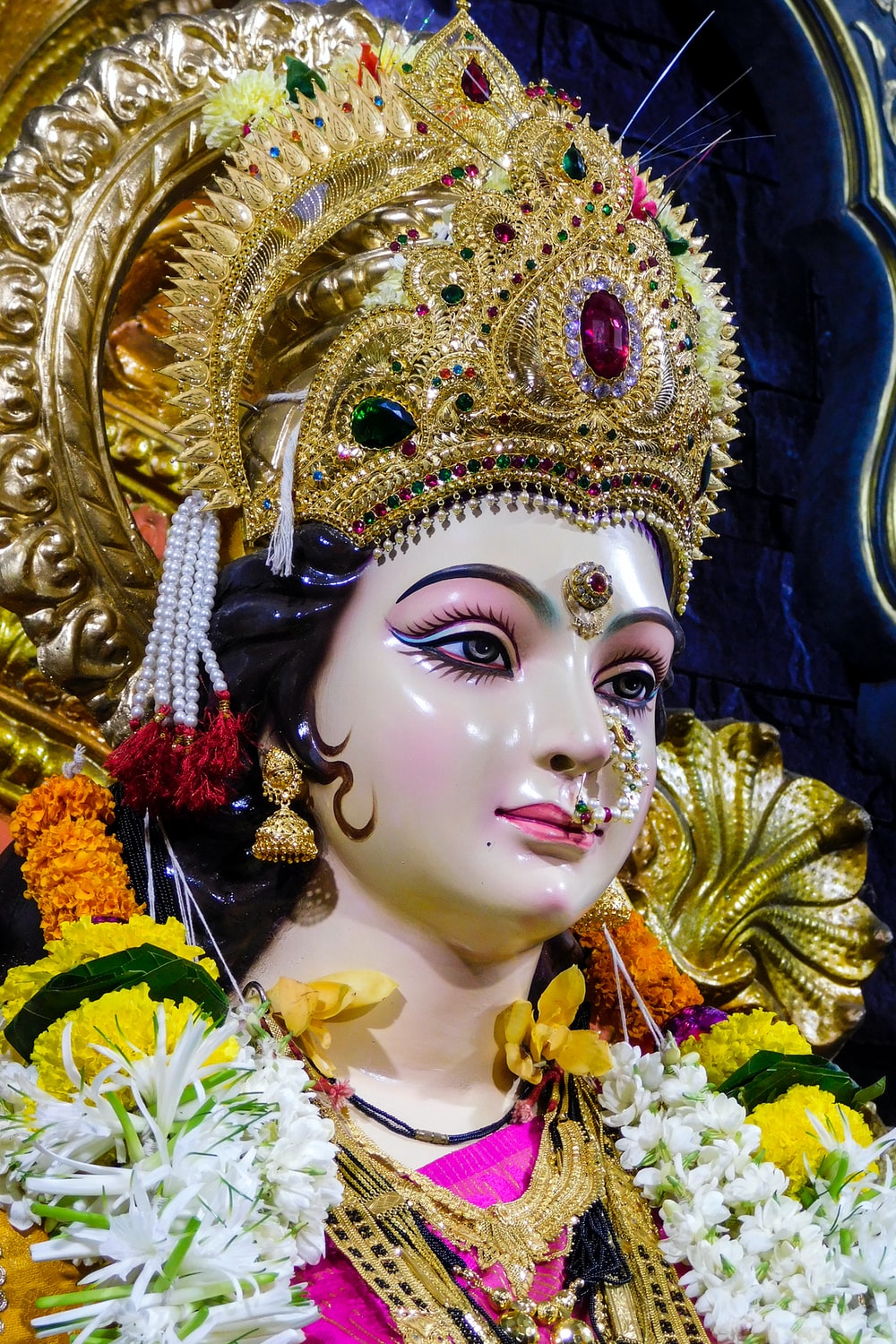 gold and white hindu deity figurine photo