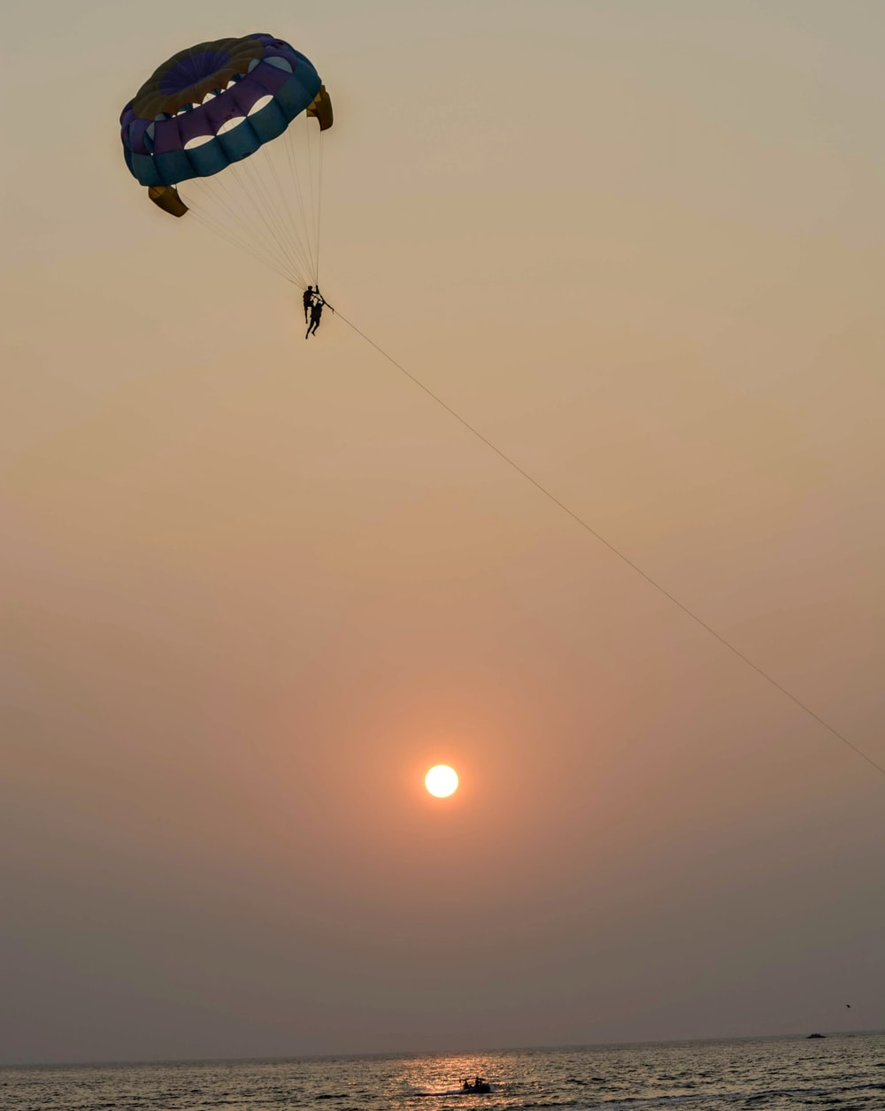 person parasailing over sea water during daytime photo
