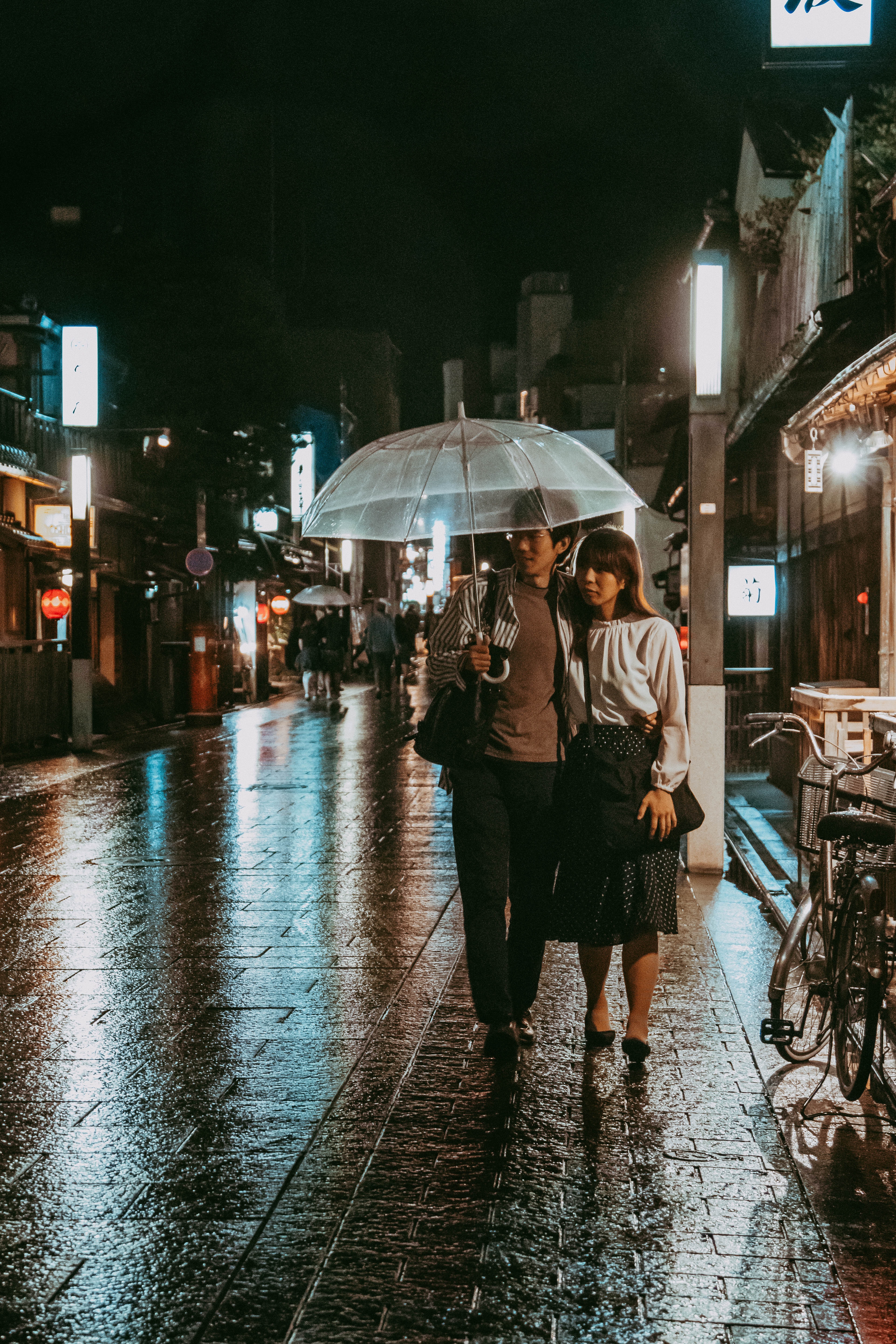 Couple Walking on Street Under Umbrella during Night Time · Free